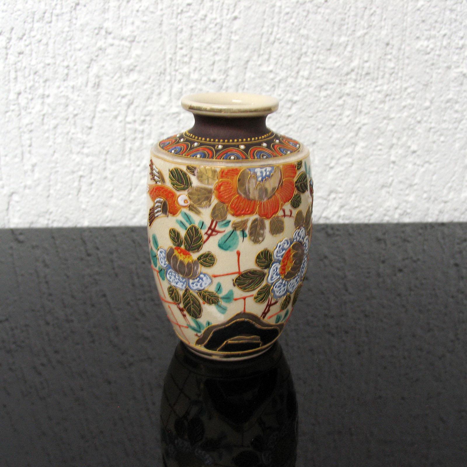 Mid-century Japanese ceramic vase, beautifully decorated with flowers and foliage. Marked under the bottom 