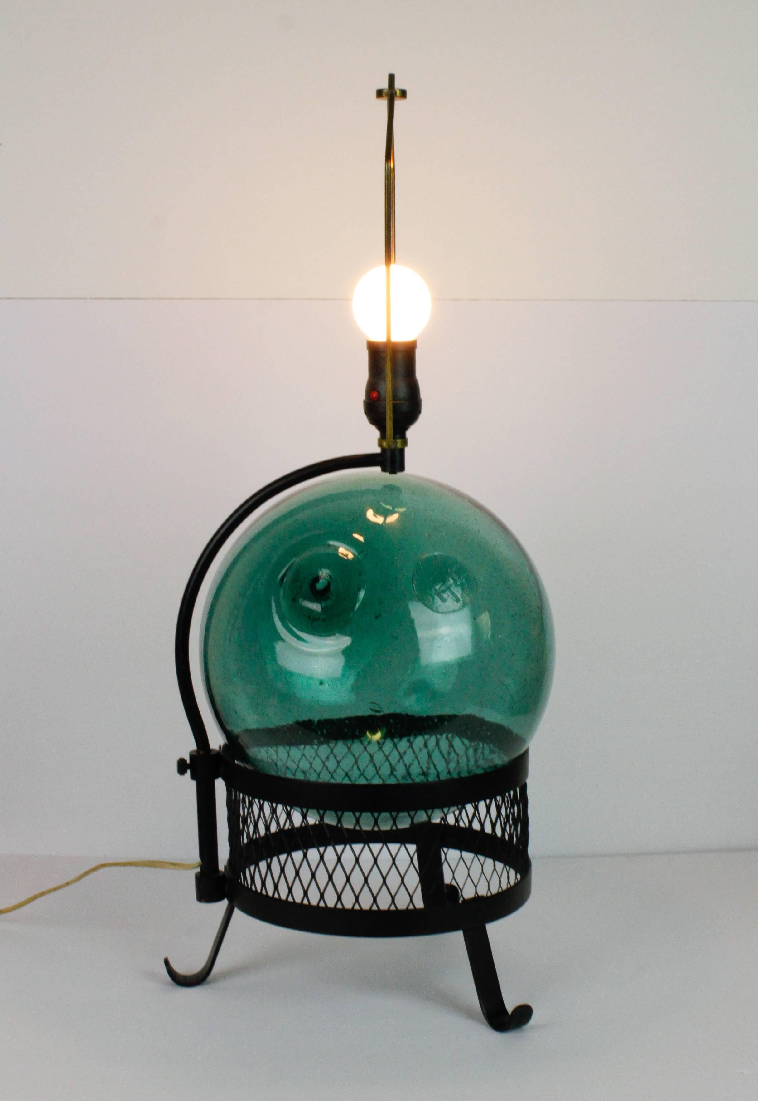 Midcentury Japanese fishing float lamp with black metal mesh base. In excellent vintage condition. Float is marked with 