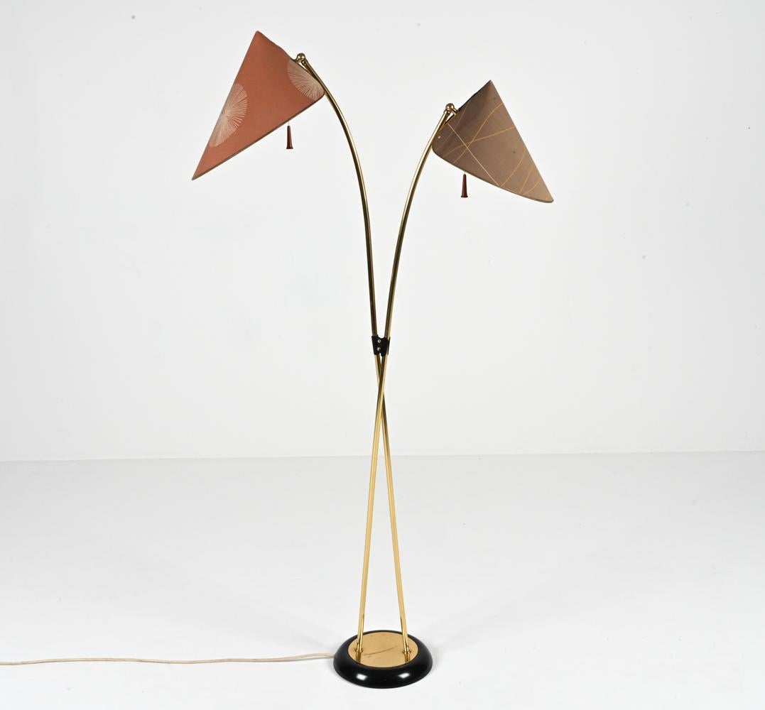 With its thin, delicately curved stems and original cone-form paper shades printed in abstract geometric motifs, this fabulous and rare floor lamp is a fascinating example of Japanese-inspired Mid-Century design. Likely produced in Germany or