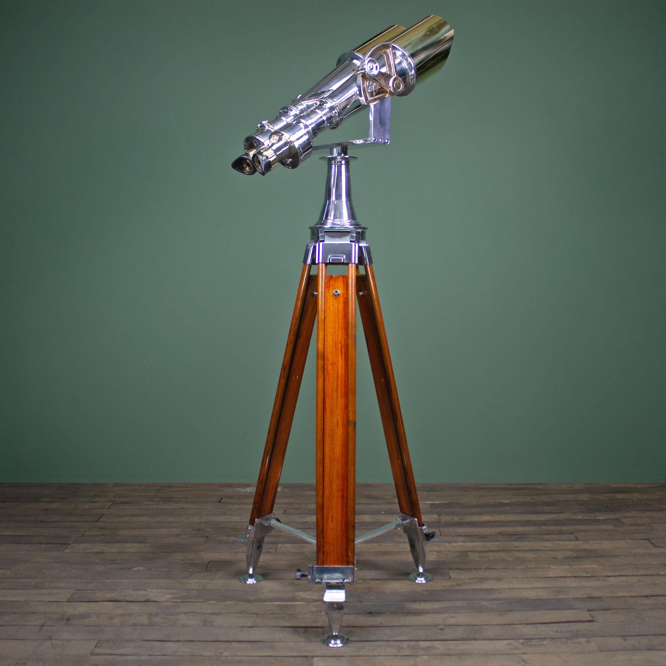 Professionally restored antique Nikon binocular telescope by Nippon Kogaku paired with a heavy duty hard wood field tripod. 

These stunning binoculars are ideal for long range viewing of wildlife, astronomy or to command attention in your home or