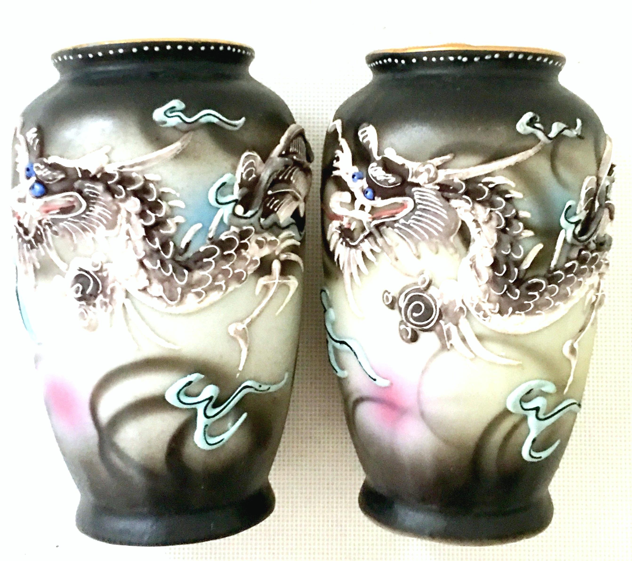 Mid-20th century Japanese porcelain hand-painted Moriage dragon ware pair of bud vases. Each vase is signed on the underside, hand-painted-made in occupied Japan.