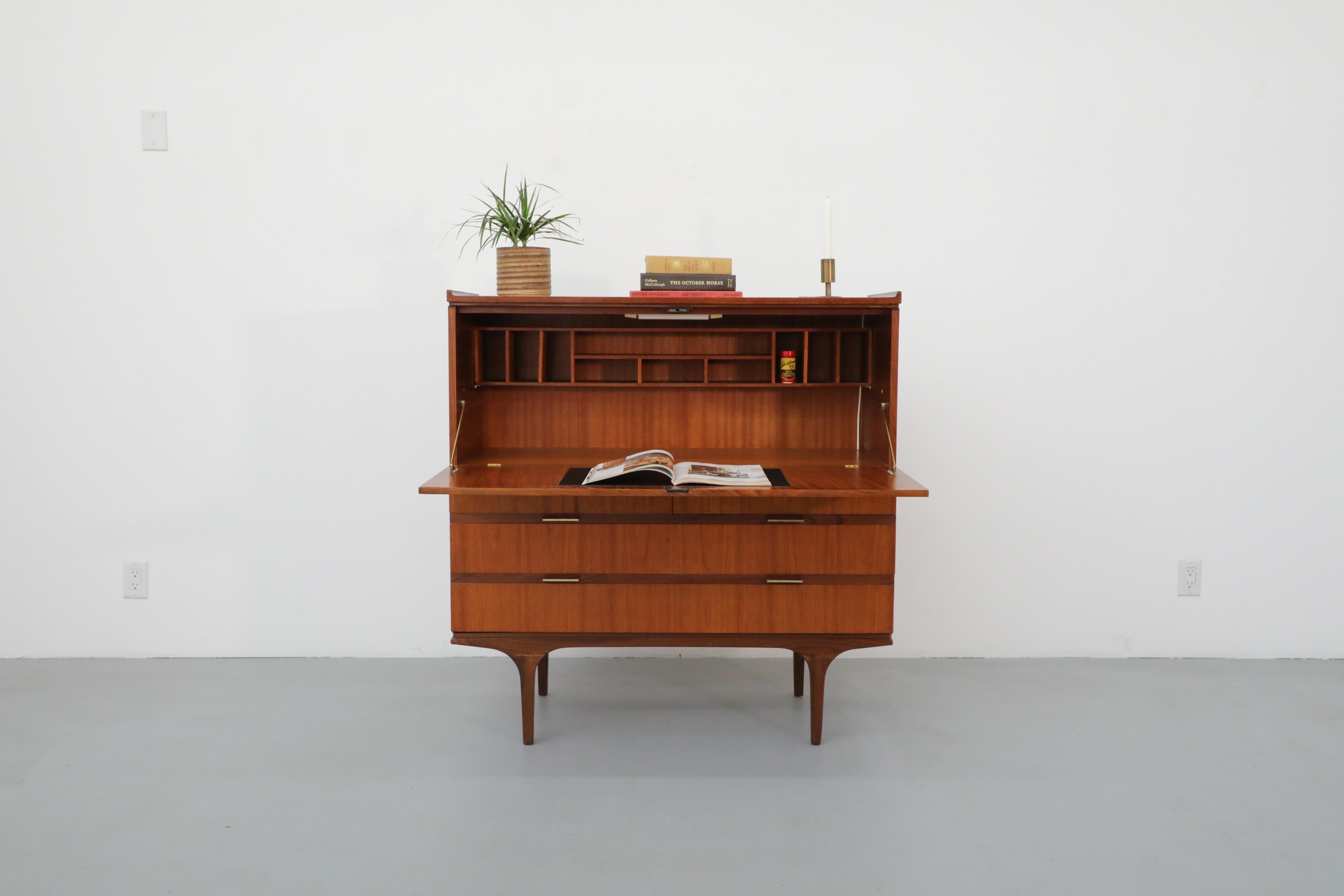 Mid-Century, Japanese Style Desk and Dresser by British manufacturer Meredew. Despite its compact size, this 1960's cabinet provides ample storage. The piece has a magnetic drop-down door that opens to reveal a writing bureau with letter