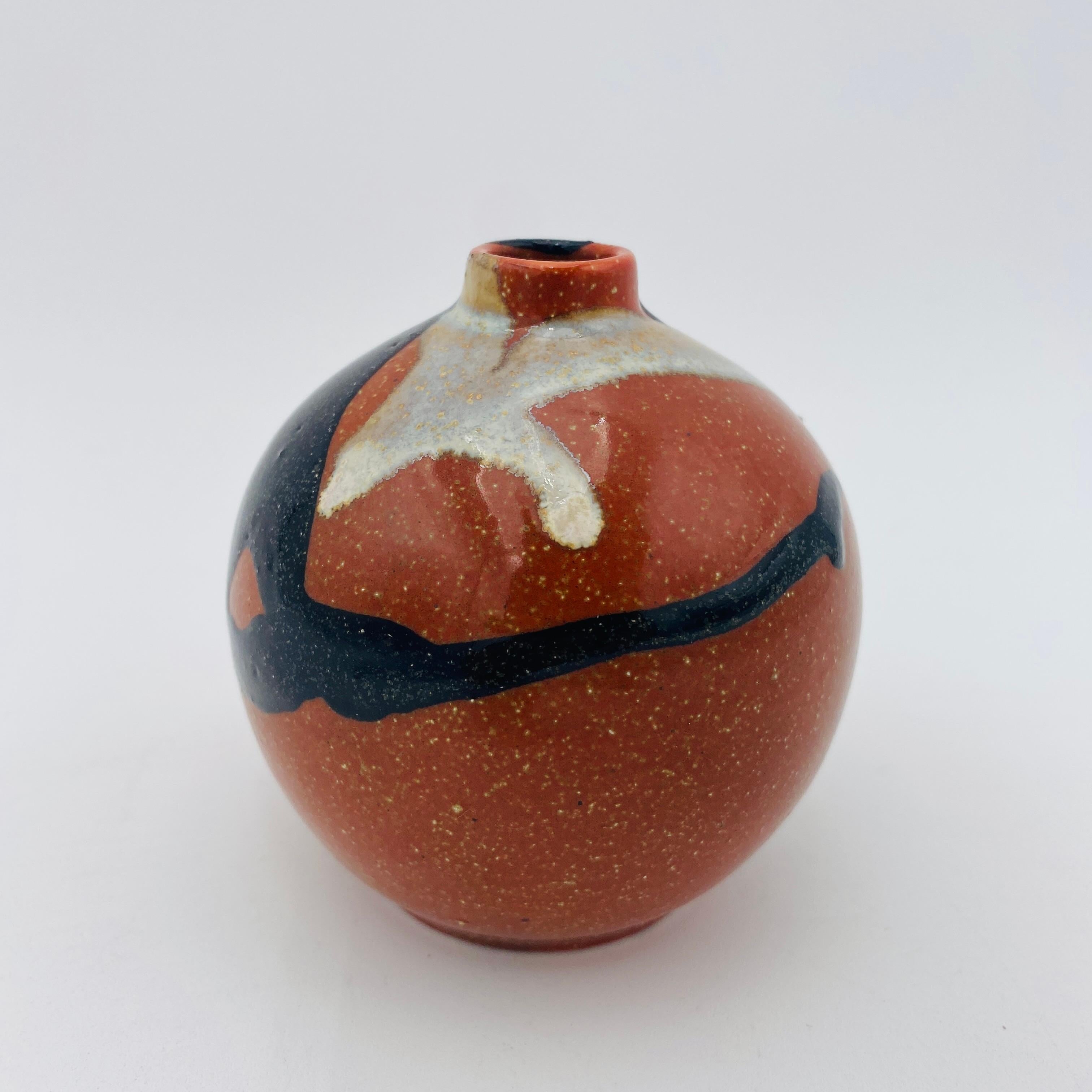This is a mid-century ceramic vase weed pot made in Japan in the 1960s. It is glazed on the interior and exterior so it can be used as a vase or weed pot. The original made in Japan sticker is on the bottom. 