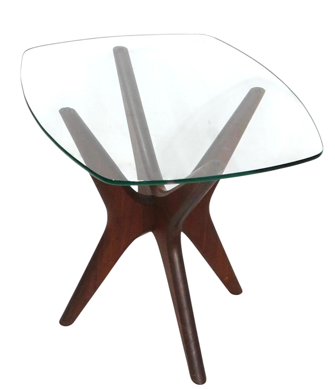 Iconic Mid Century Jax side table, designed by Adrian Pearsall for Craft Associates, circa 1960's. The table features a Jax form sculpted walnut base, with original tempered glass top. This example is in very good, original,  clean condition,