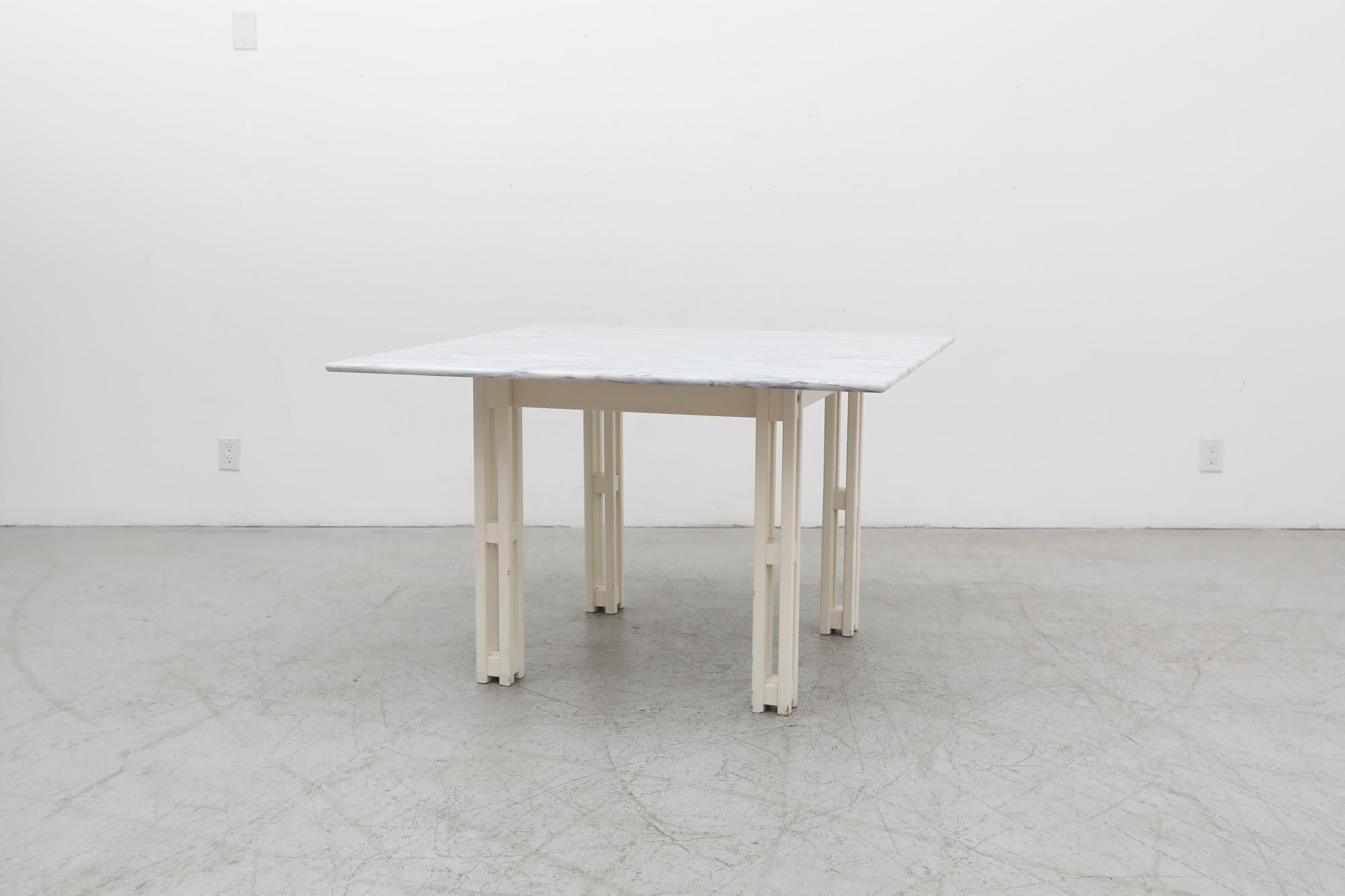 Mid-Century Jean Maneval style square marble dining, card or center table. Striking architecturally structured design with wooden erector set-like frame with marble top. In original condition with visible wear, consistent with its age and use.