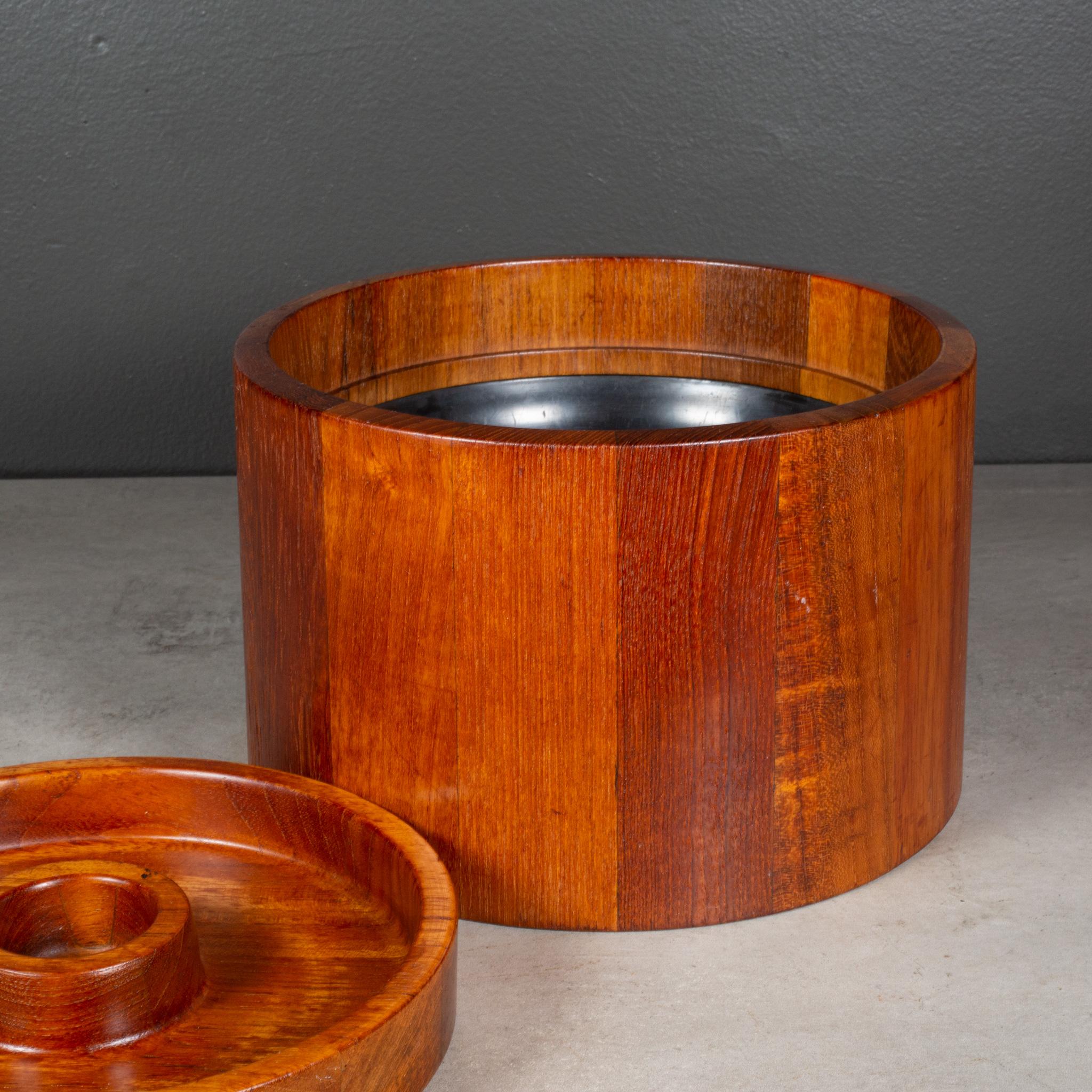 ABOUT

An original mid-century Jens Quistgaard Teak round ice bucket with black, plastic insert. Impressed stamp on the bottom with maker's mark.

    CREATOR Dansk, Denmark.
    DATE OF MANUFACTURE c.1950-1960.
    MATERIALS AND TECHNIQUES Teak,