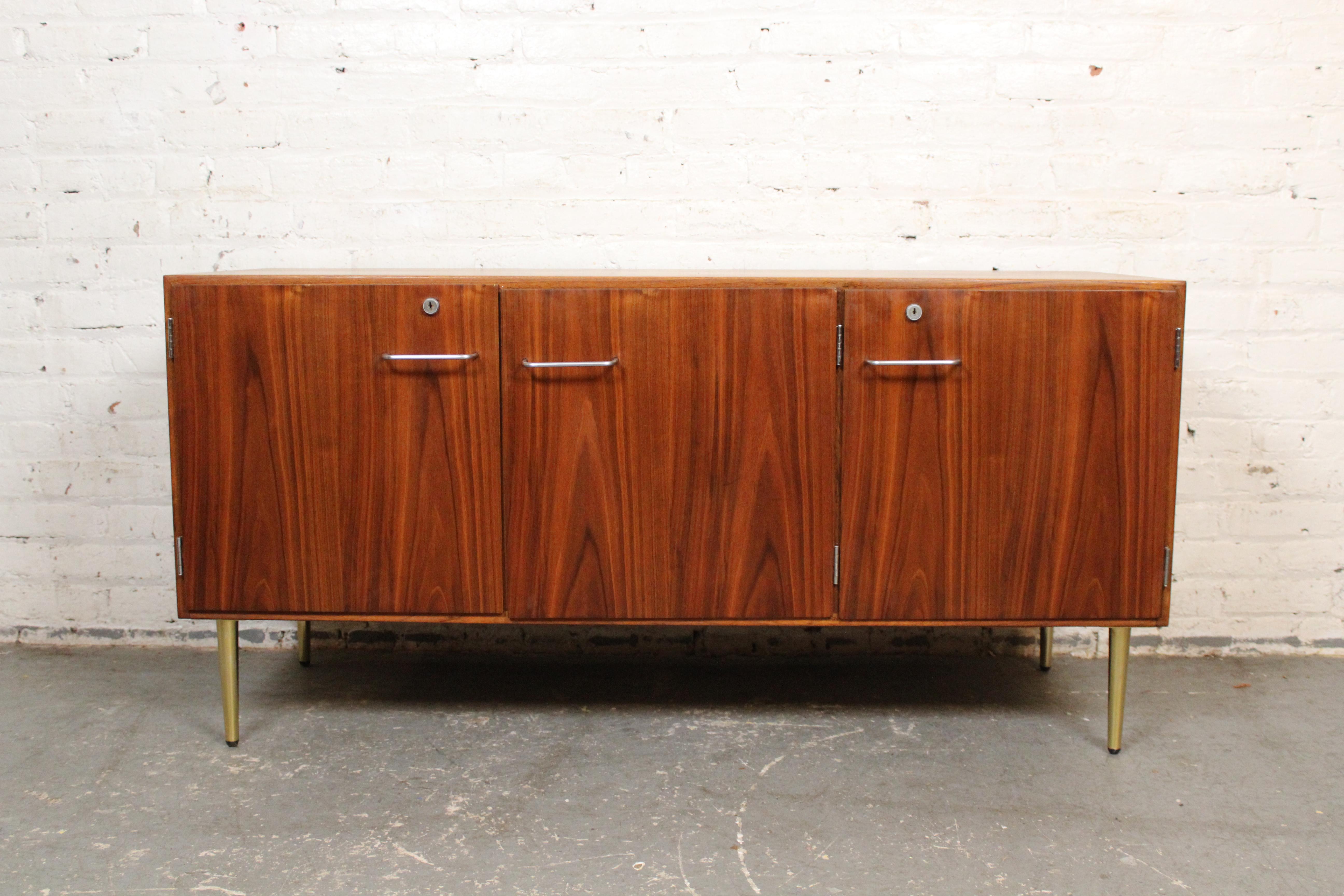 Bring home the Transatlantic elegance of genuine mid-century modern vintage design with this luxurious credenza designed by legendary Danish industrial designer Jens Risom for his namesake American firm. Originally made for IBM's Armonk, NY