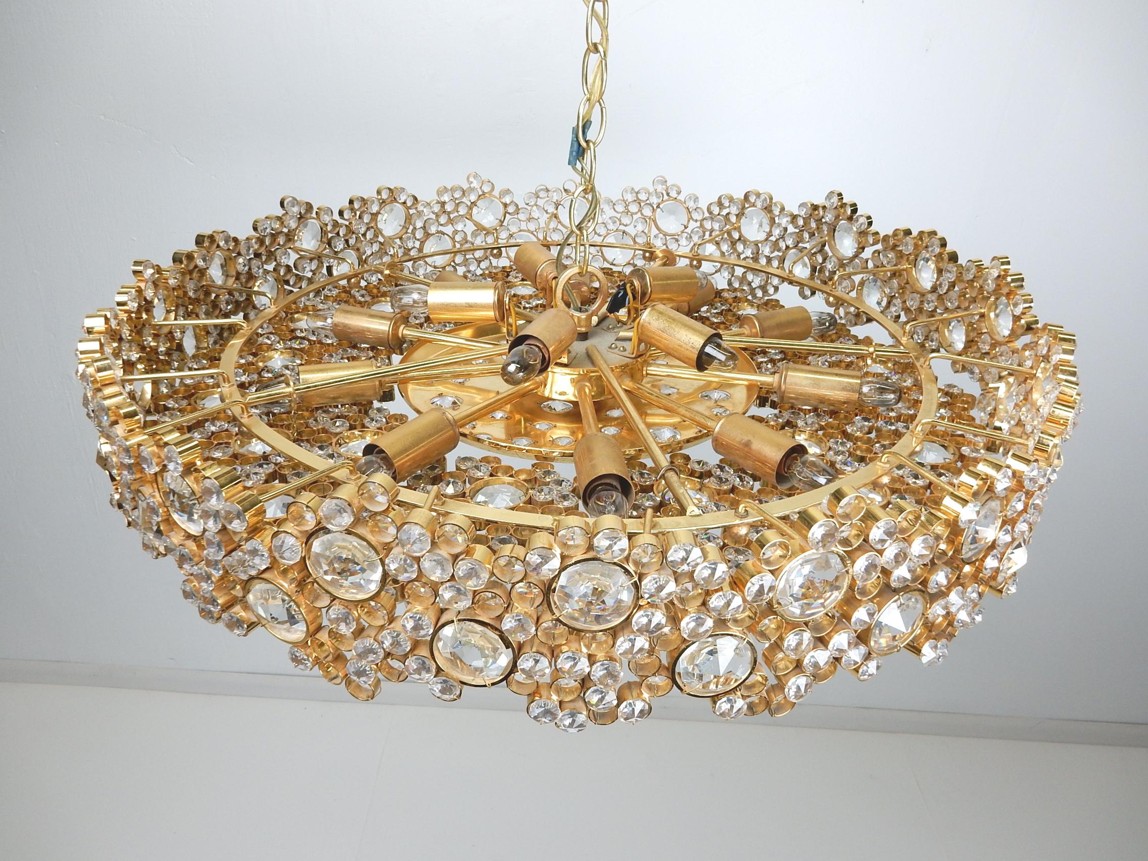 Fabulous 1960s 24-karat gold-plated and crystal glass chandelier by Palwa (Palme & Walter) of Germany.
This is the big one with 15 candle bulbs measuring over 26 inch wide.
6 inches tall sides on a 20 inch drop chain.
Marked Made in Germany in 2