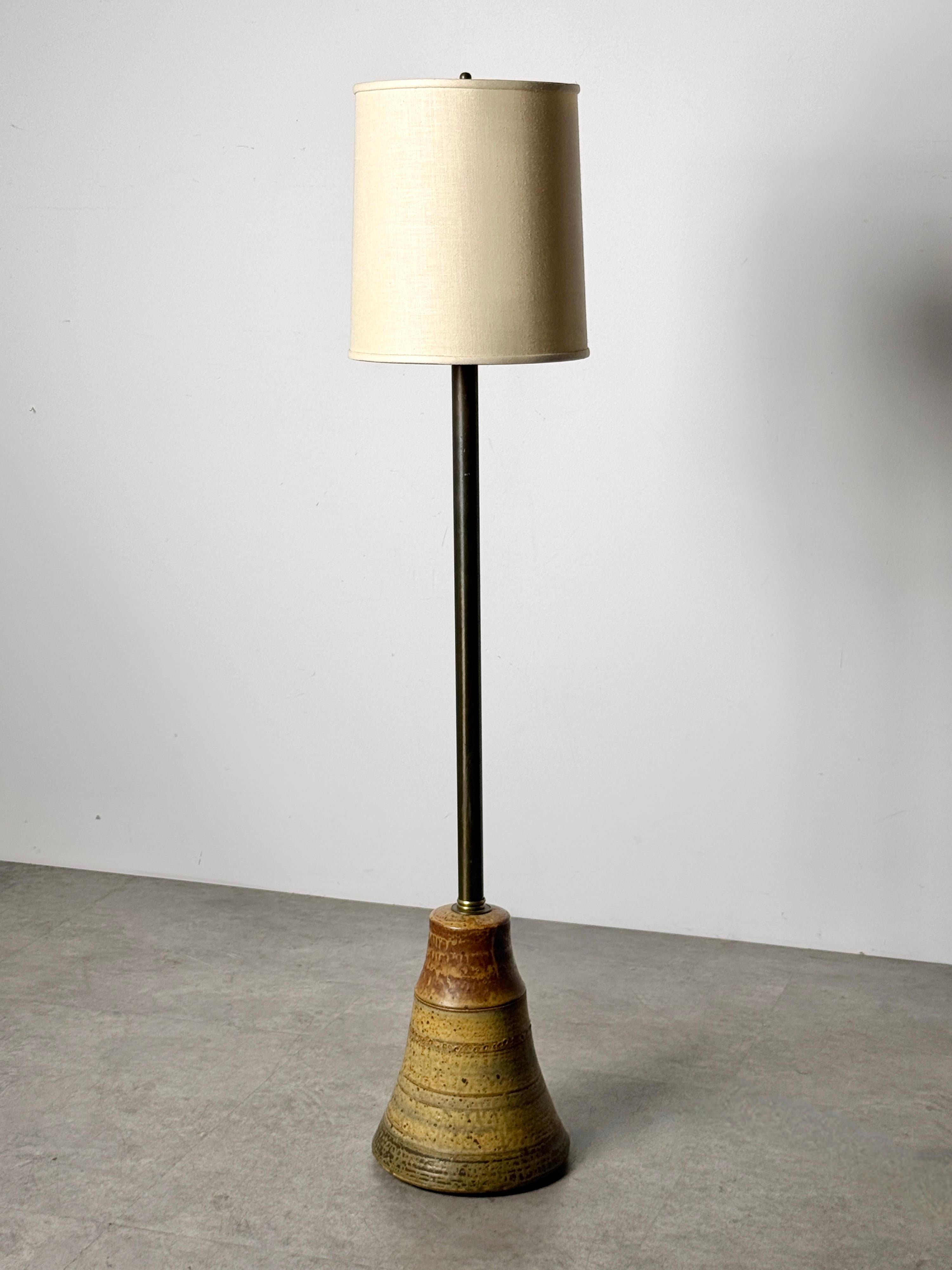 Rare floor lamp by renowned Cranbrook ceramic artist John Glick 
Plum Tree Pottery circa 1960's

Conical base formed of stoneware in earth toned glazes
All original example with drum shade
Signed with impressed mark to underside

52 inch overall