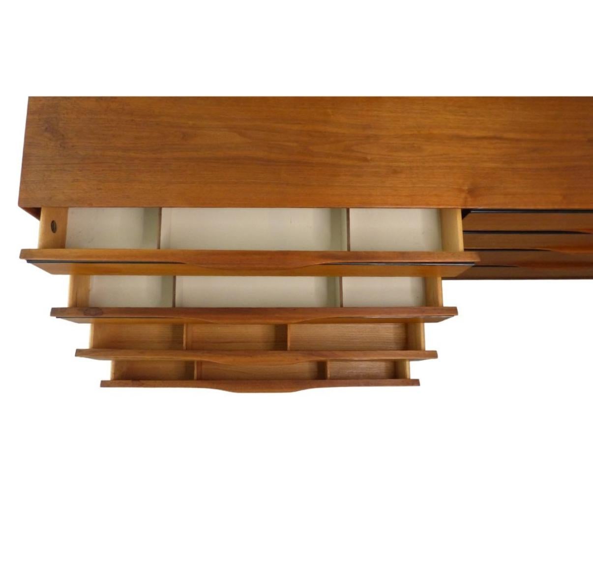 Stunning very clean mid century John Kapel for Glenn of California 8 drawer walnut and black lacquer dresser credenza. Very clean all original dresser credenza with all drawer dividers. beautiful sculpted handles. All drawers are on metal glides