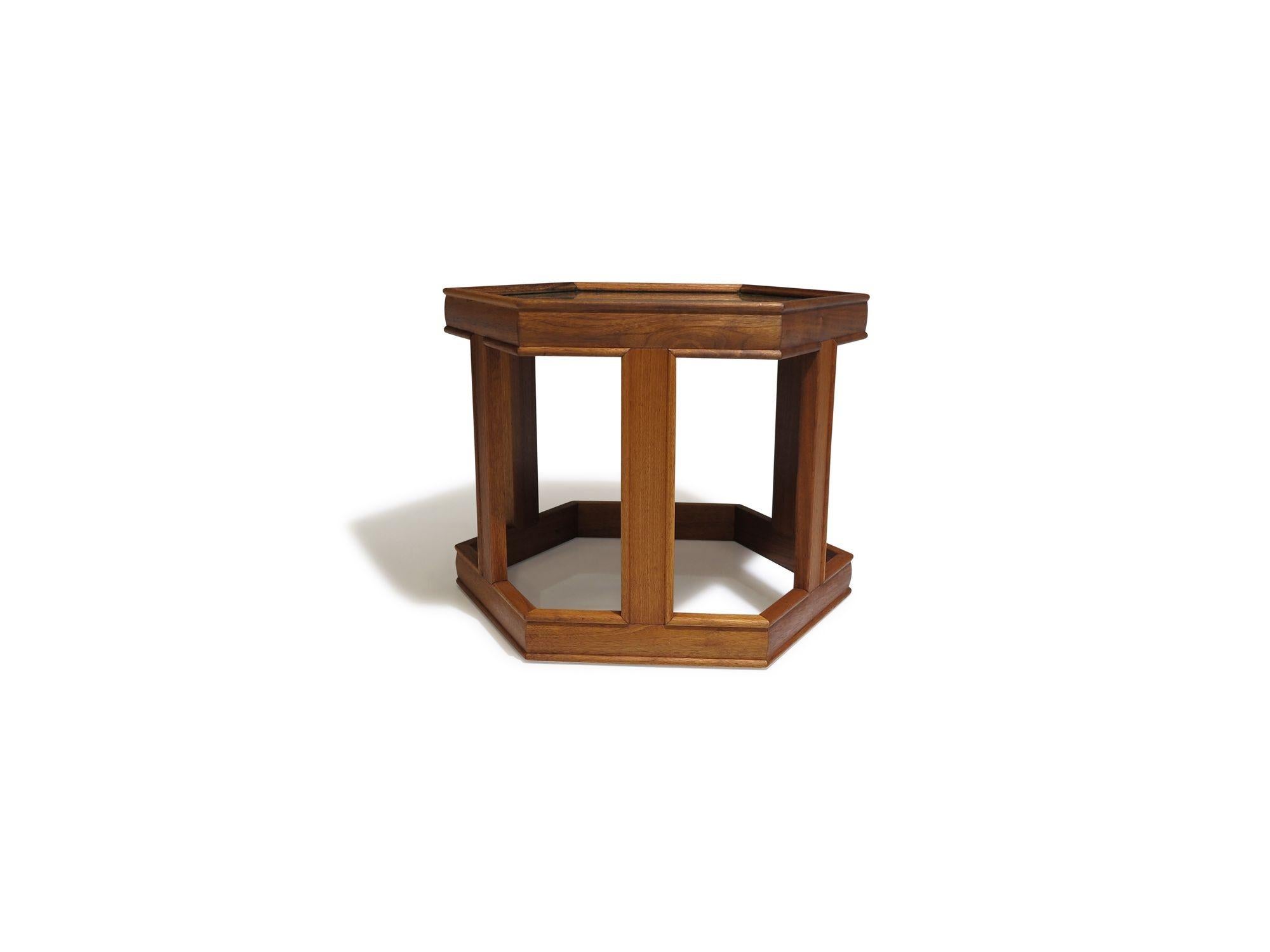 Walnut side tables designed by John Keal for Brown Saltman, circa 1960, United States. Crafted from solid walnut, these tables feature a hexagonal shape with glass surfaces. Fully restored with a natural oil finish, they are in excellent condition