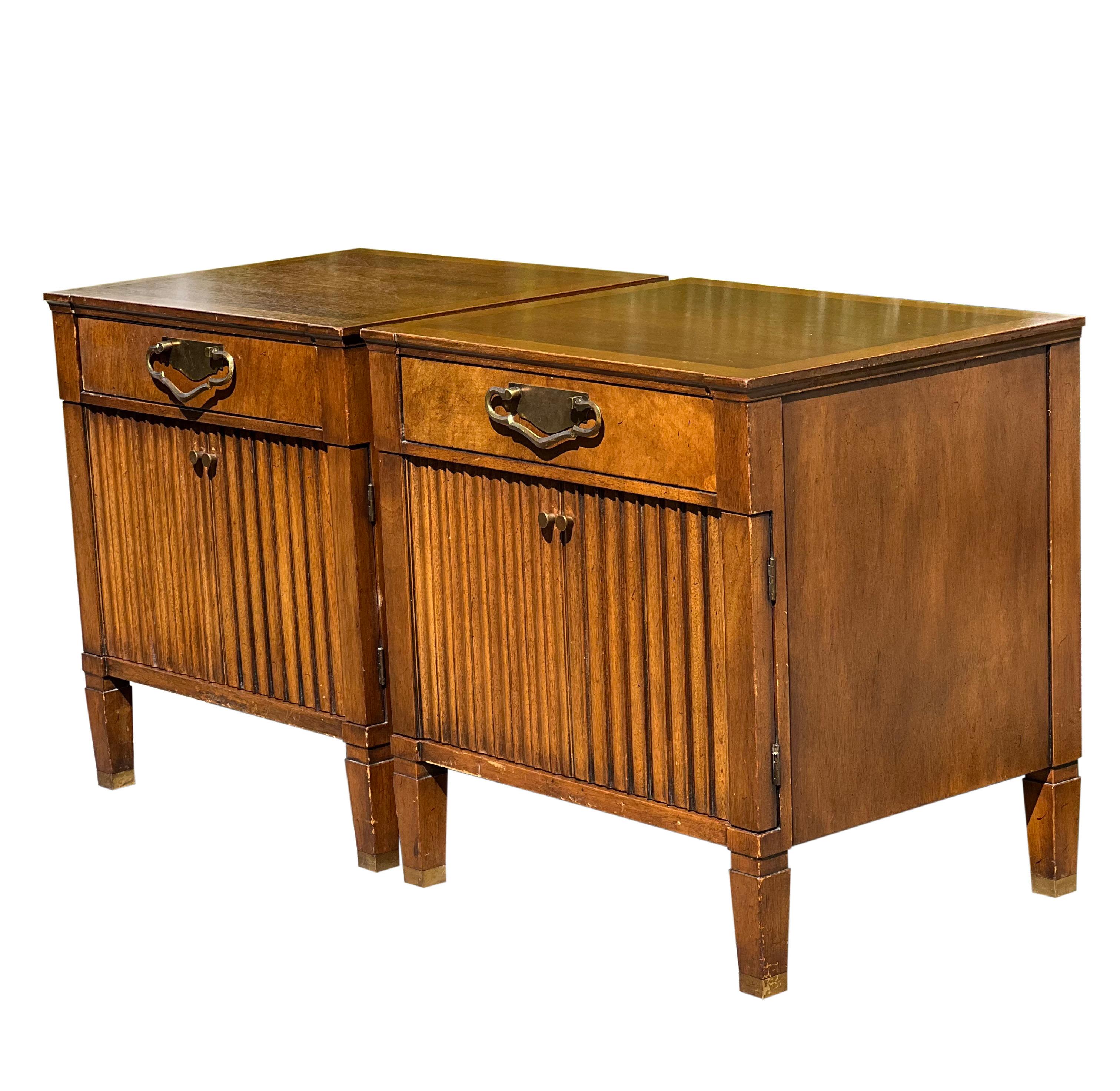 Fabulous Mid Century nightstands by John Stuart for Johnson Furniture Company, 1960's.

Crafted of rich walnut, the nightstands feature elegant oak banding on the tops. Each one has a single drawer and a two door cabinet with carved groove detail.