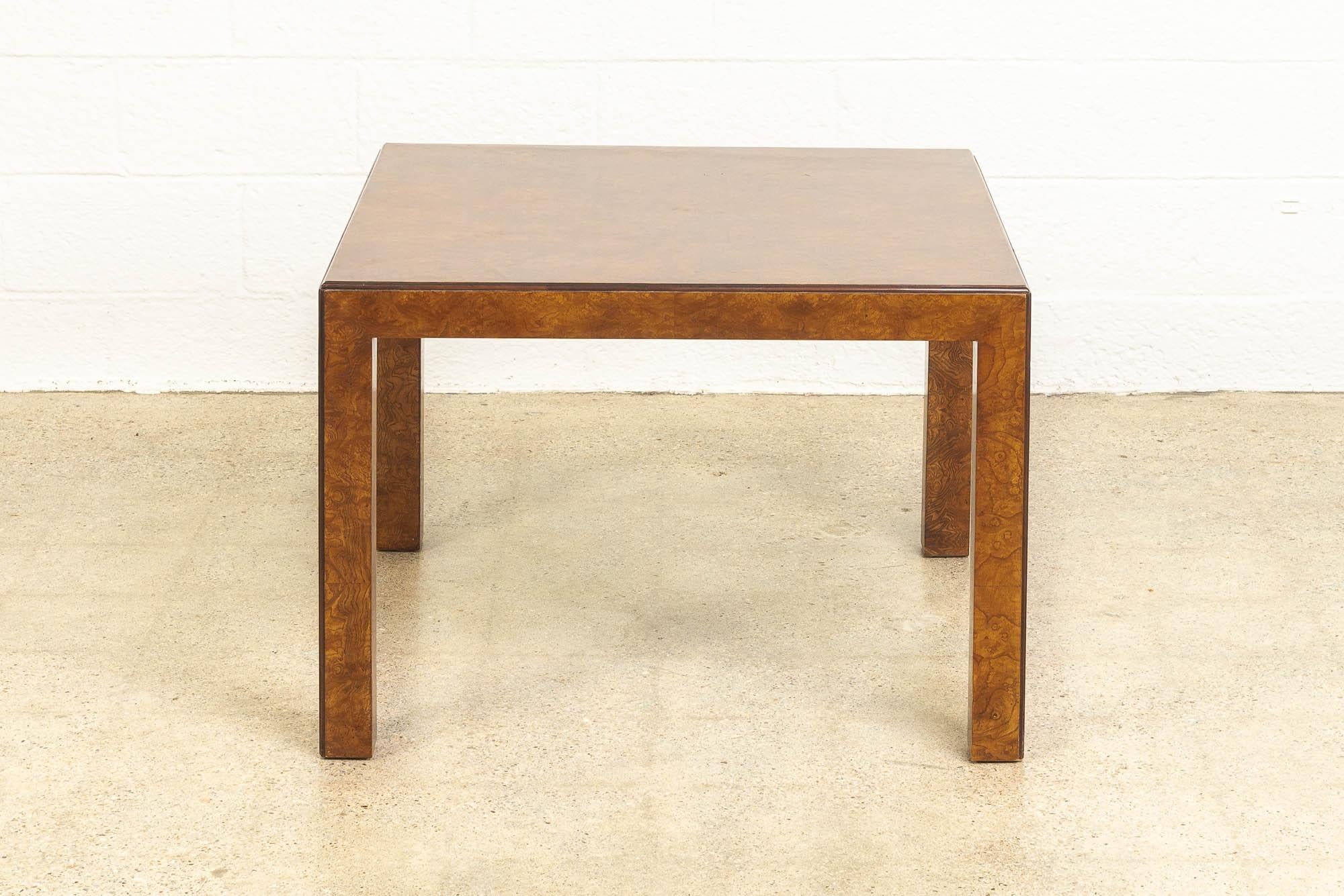 This Mid-Century Modern John Widdicomb Square burl wood coffee table circa 1970 features a Classic Minimalist design with clean geometric lines. The table is well-constructed from solid burl wood and the elegant unimposing design features a gorgeous
