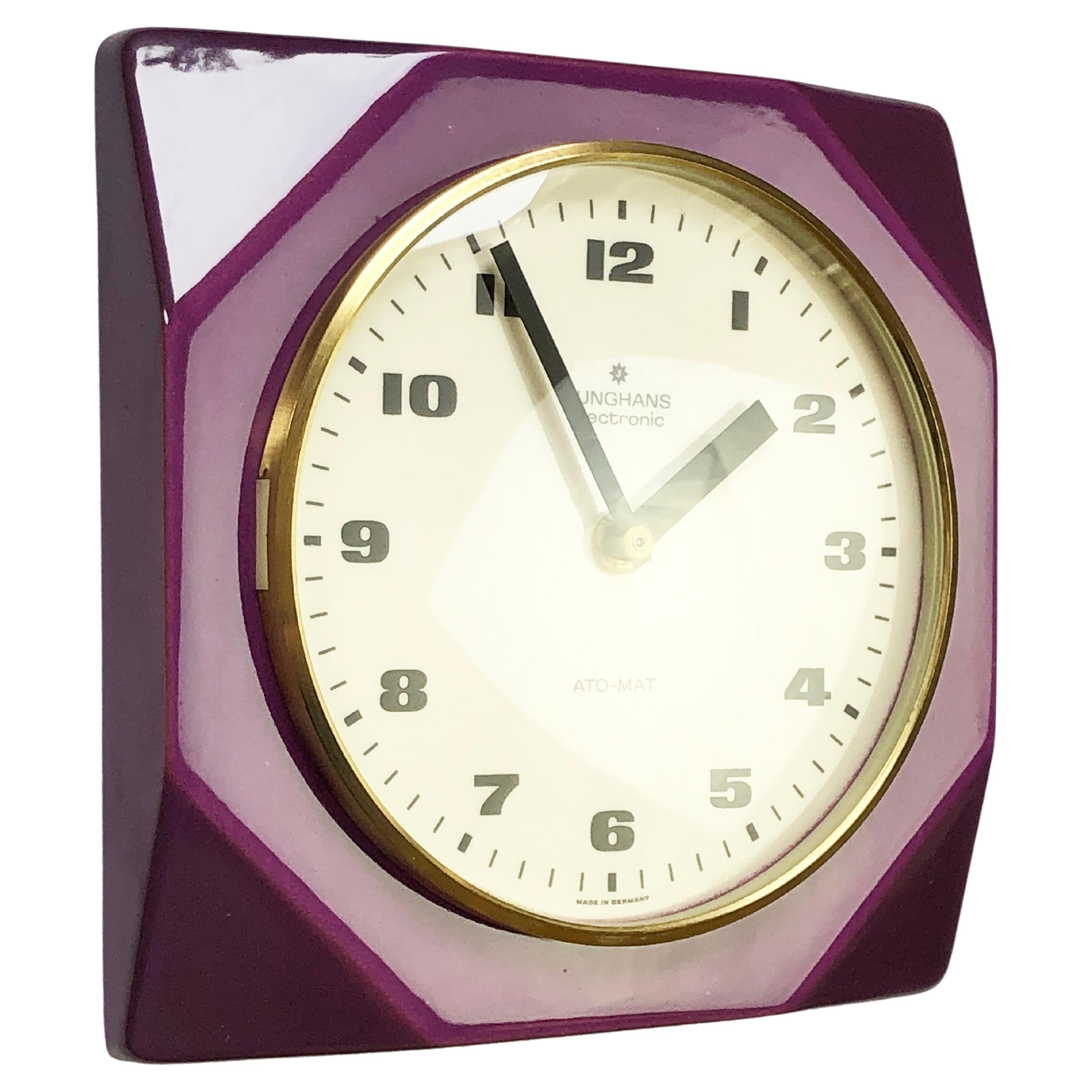 Outstanding colours & design by the famous German watch- and clock maker JUNGHANS.
Quite a futuristic approach, a masterpiece of mid-century design.
Made in the late 50s to 60s, this wall clock is made from a mid purple, glazed ceramic.
Geometrical