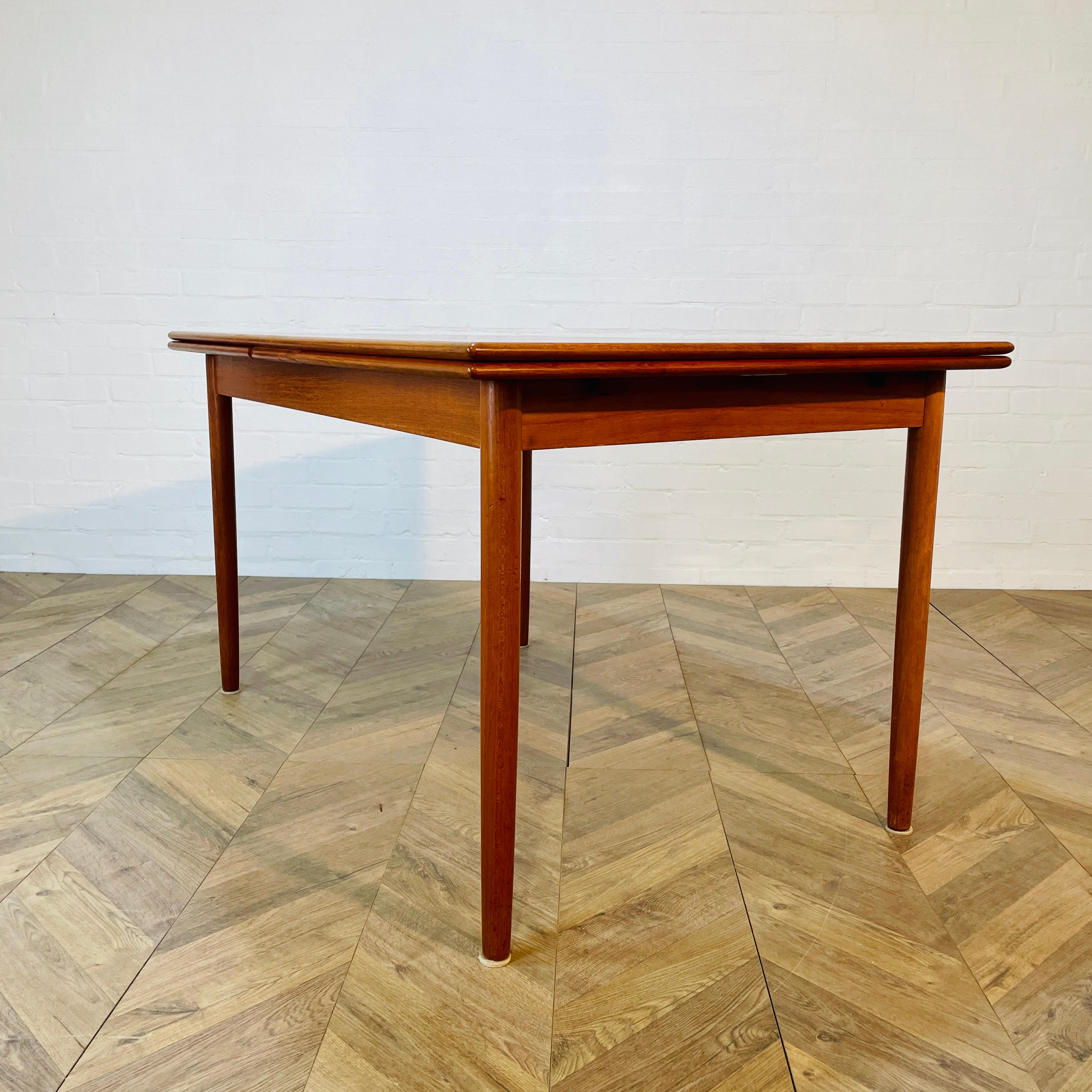 Vintage Mid-Century Extending Dining Table Designed by K A Jorgensen for A/S Mobelfabrik, 1974.

A beautifully designed table, with extending leaves, which are concealed underneath. With a bullet edge and in good vintage condition, with light wear