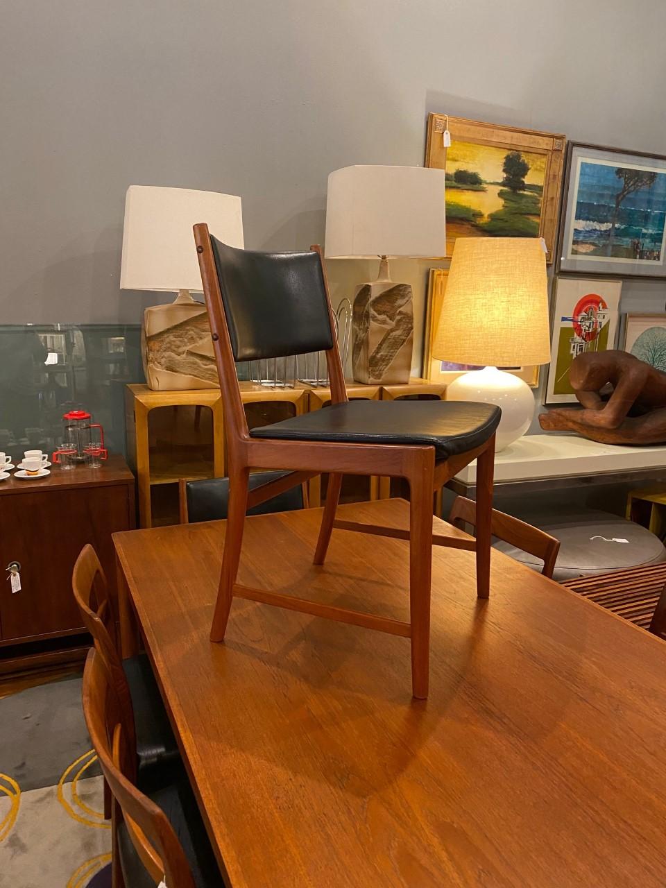 Kai Lyngfeldt Larsen, set of four dining chairs, teak, leather, Denmark, 1950s these elegant teak dining chairs are both stately and modest. The set includes 2 captain chairs and 2 dining chairs. The teak frame beautifully complements with the