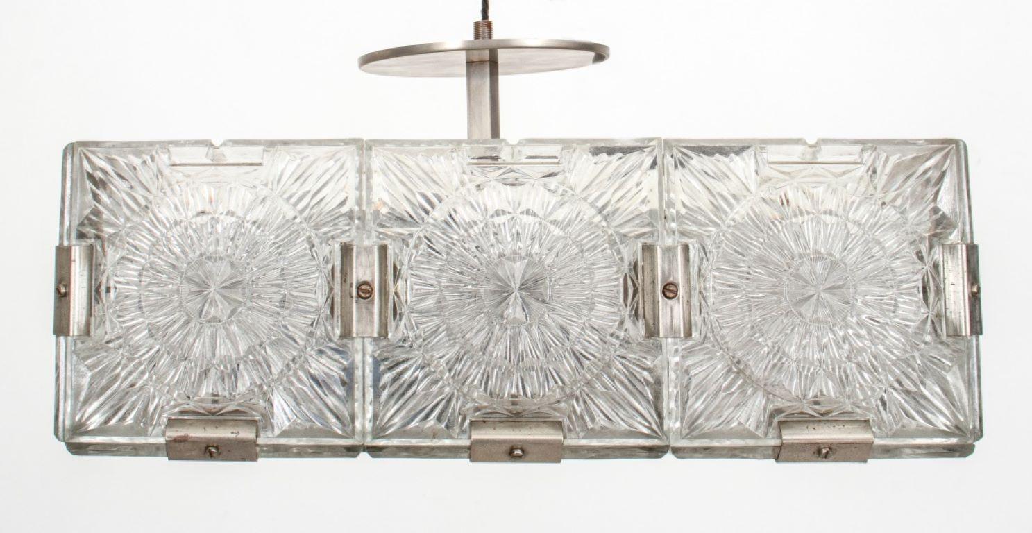 Mid-century modern Czech Glass pendant light attributed to the Kamenicky Senov Factory, 1970s, in the form of a square pressed glass box composed of 21 individual square glass panels. 

Dealer: S138XX