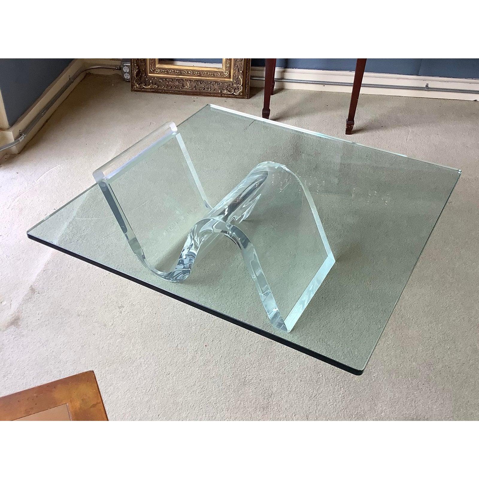 Very unusual Karl Springer inspired acrylic cantilevered cocktail table with a new 3/4 inch glass top.
Our midcentury acrylic or Lucite cocktail table or coffee table is in very good condition with a very tiny chip on left end which when on a thick