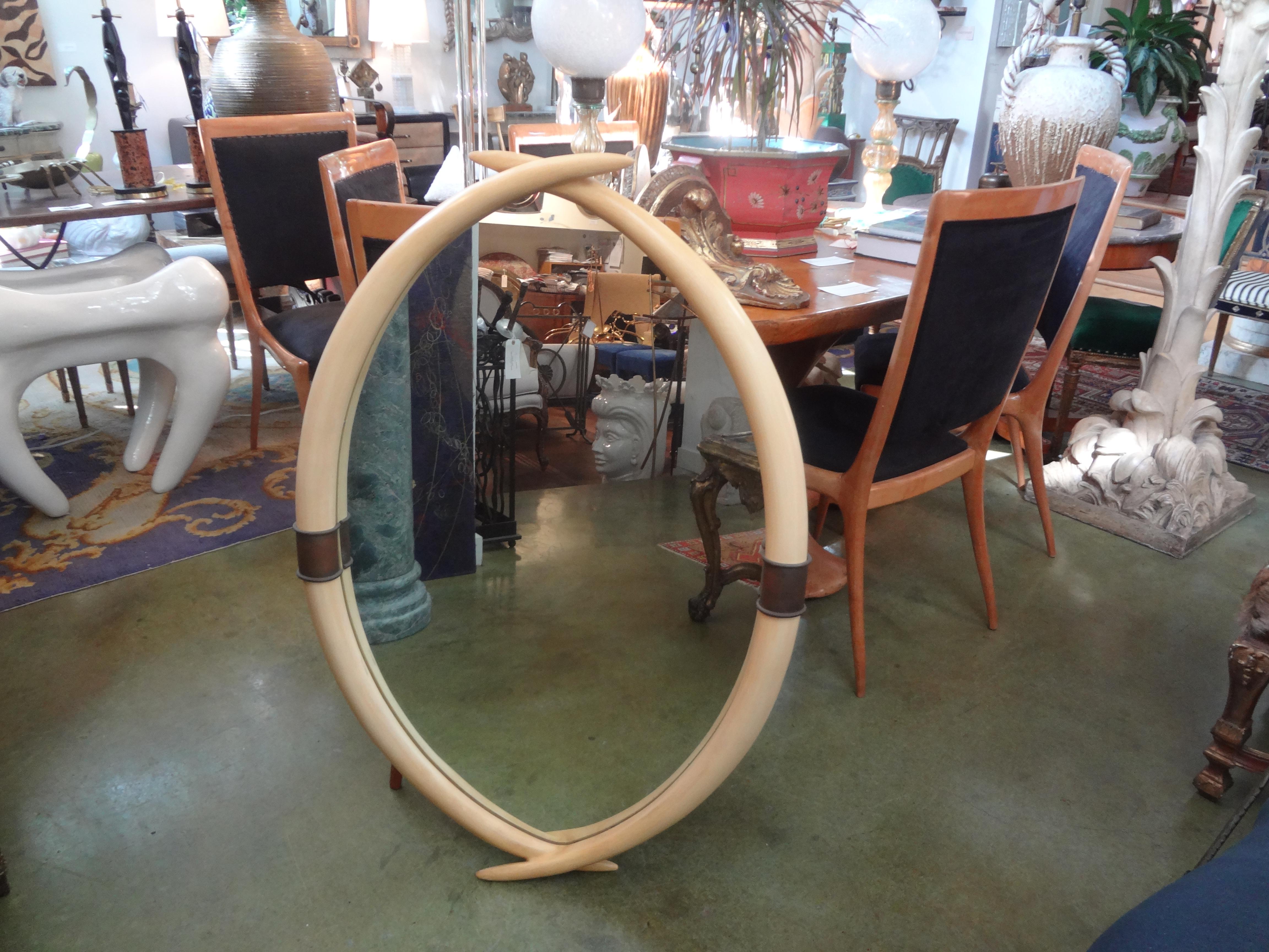 Great Hollywood Regency faux tusk mirror with brass keystones in the manner of Karl Springer. This interesting tusk mirror was made by Chapman in 1976. The original label is attached to the back. Featured mirror is in very good vintage condition and