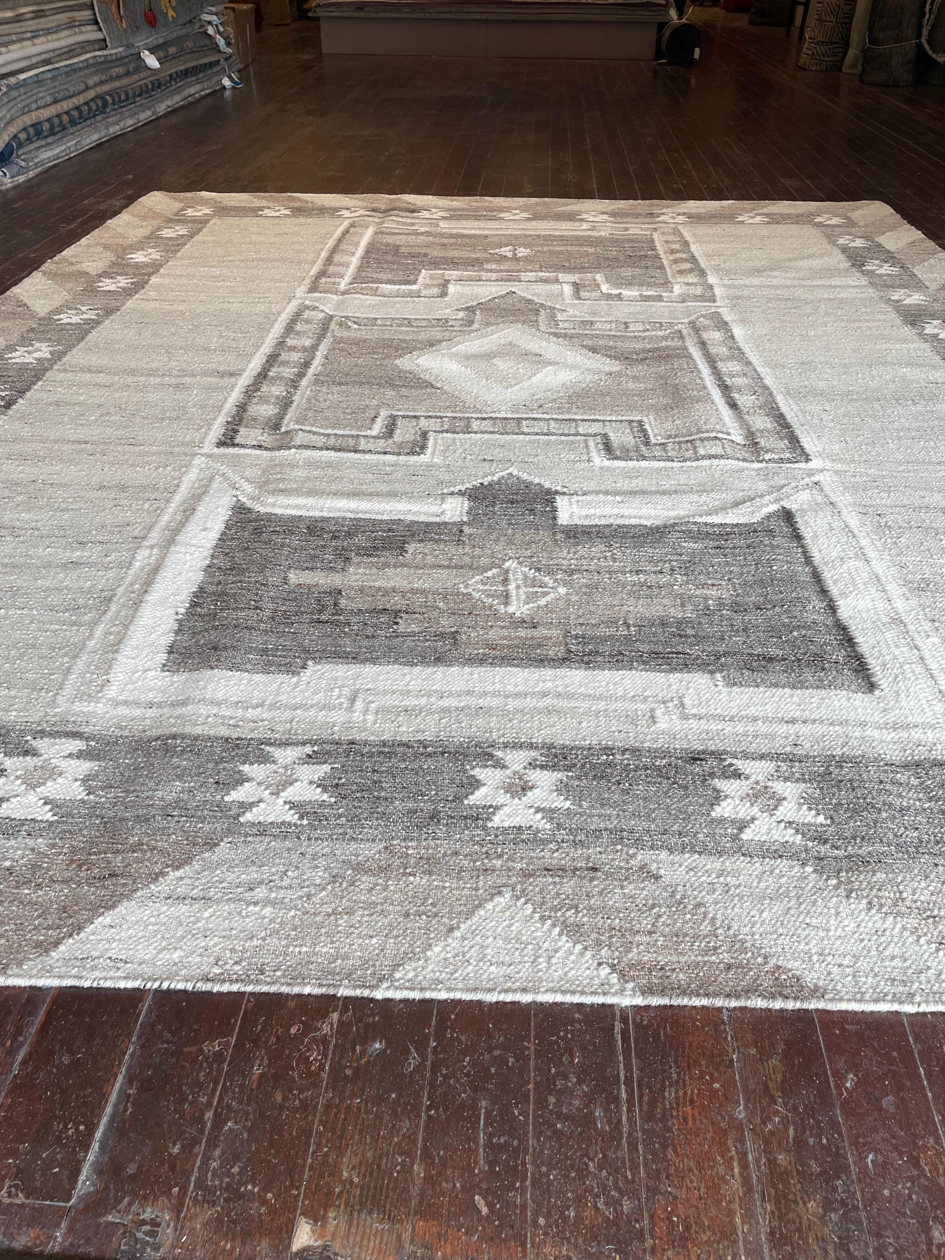 Immerse yourself in the timeless simplicity of this flat weave Kars rug reproduction, meticulously crafted in India. Originating from the Kars region in Eastern Anatolia, Turkey, Kars rugs are renowned for their intricate geometric patterns and deep