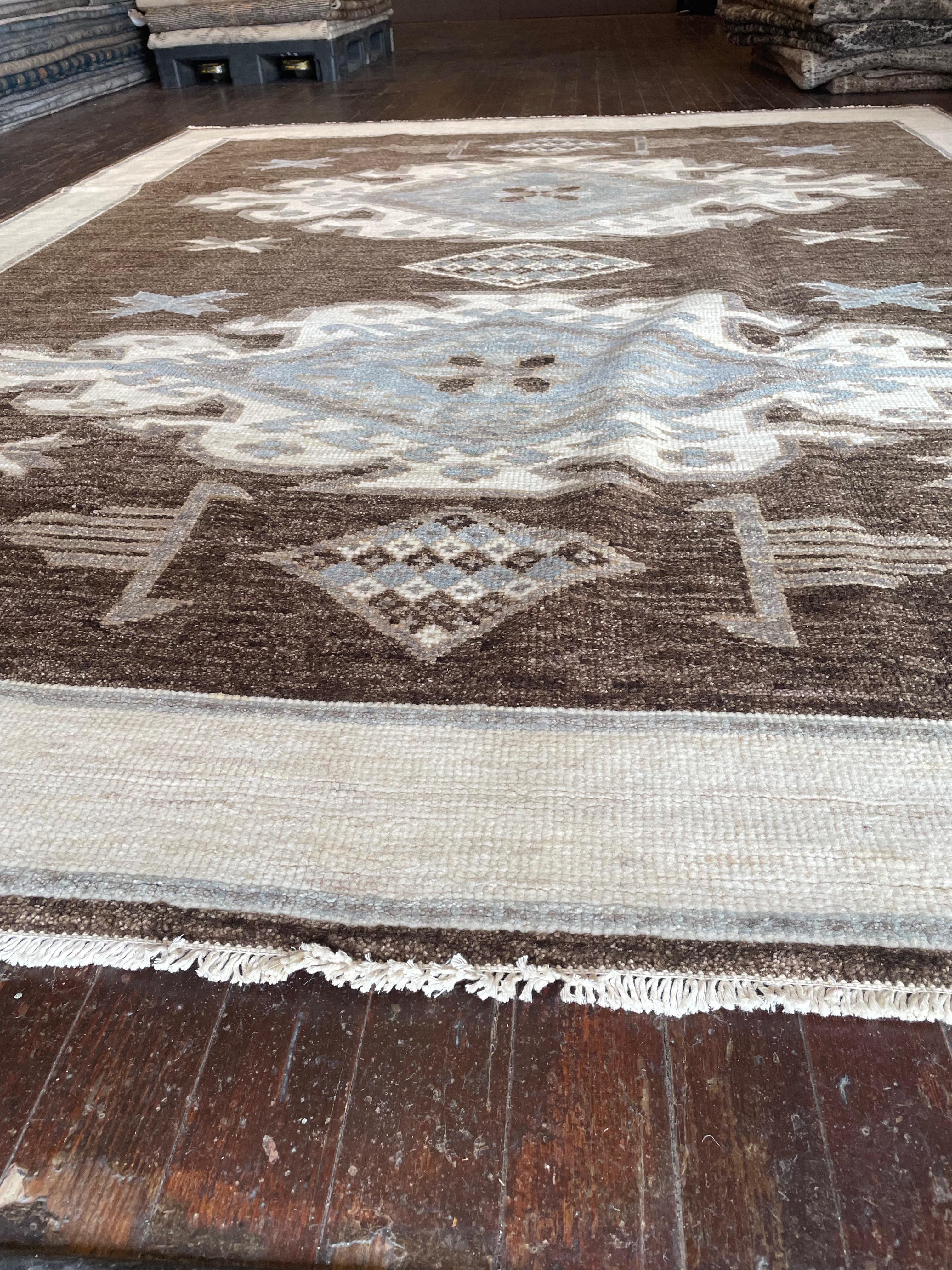 Step into a world of timeless beauty with this exquisite reproduction of a Kars rug, meticulously hand-knotted in Pakistan. Originally hailing from the Kars region in Eastern Anatolia, Turkey, Kars rugs are celebrated for their intricate geometric
