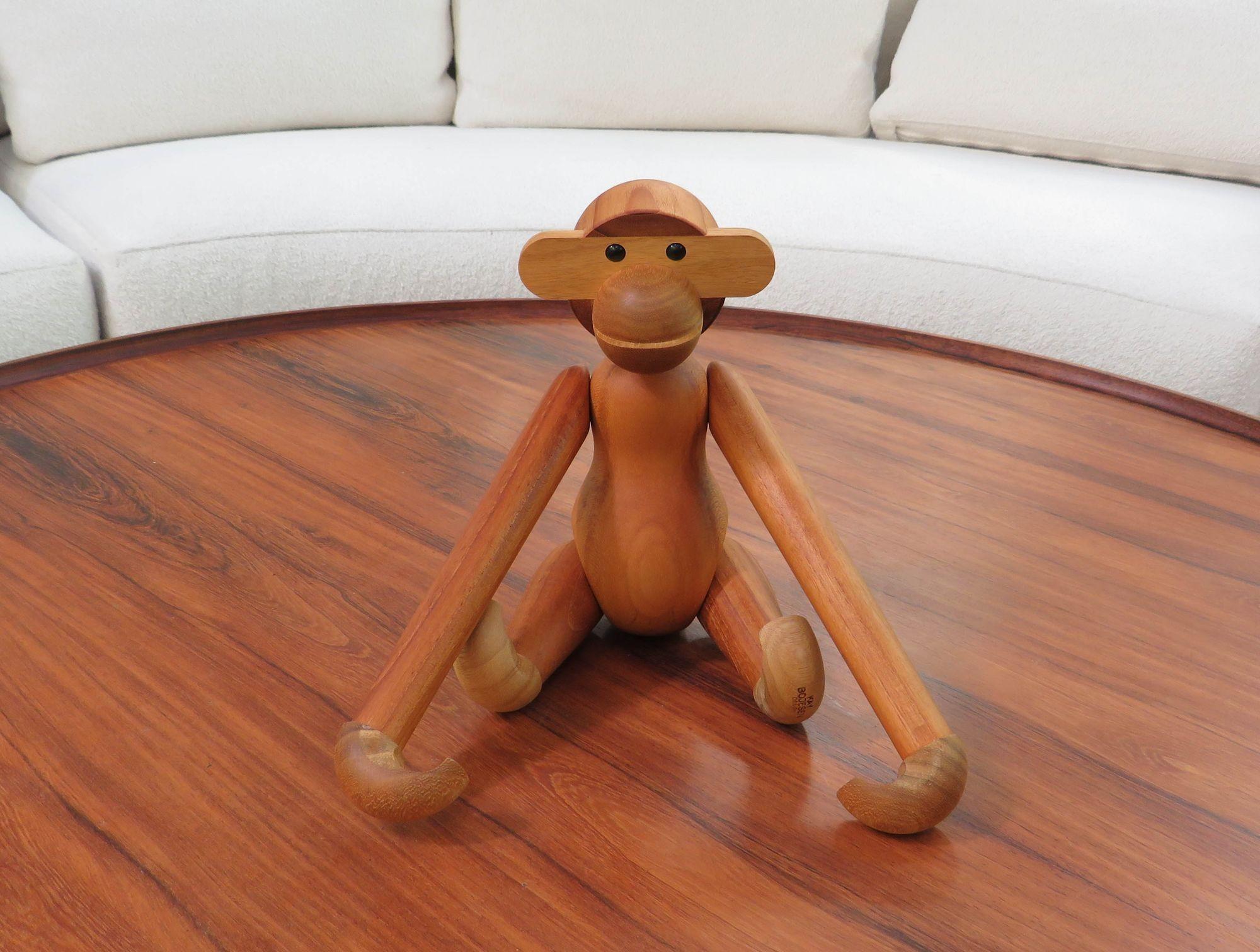 Original Kay Bojesen wooden monkey, designed in 1951, Denmark. This iconic danish toy is sculpted from solid teak and limba wood, it showcases segmented limbs and movable head, arms, and legs. Stamped