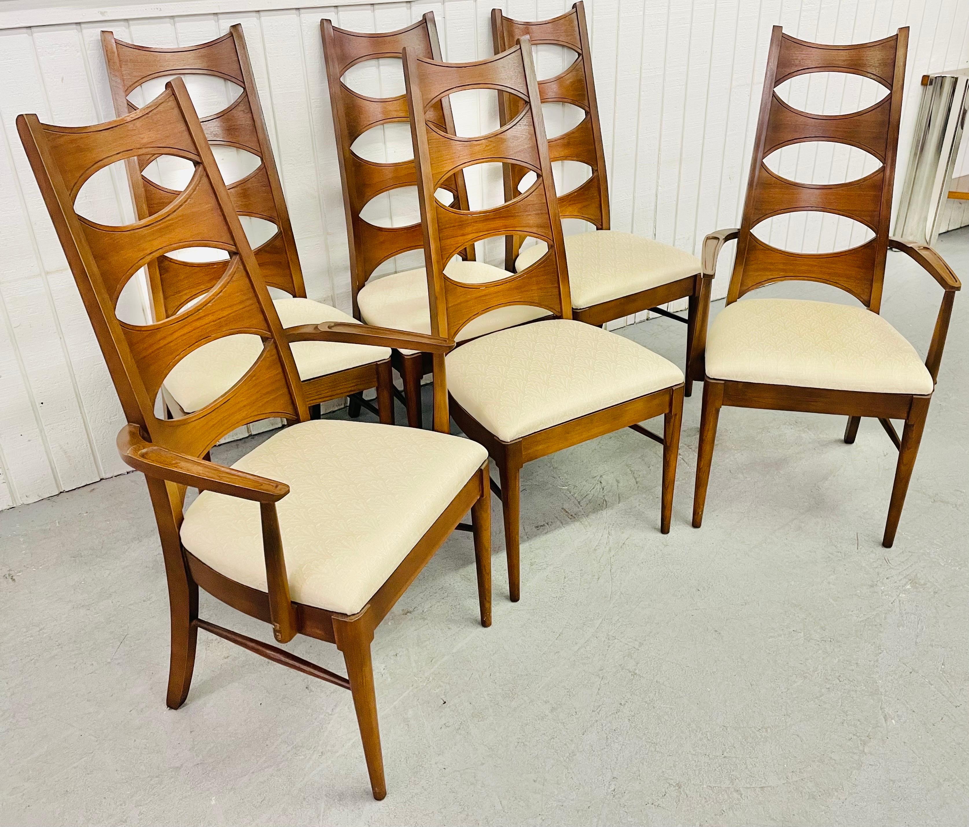 This listing is for a set of six Mid-Century Kent Coffey Perspecta Cats-Eye Walnut dining chairs. Featuring two arm chairs, four straight chairs, a cats-eye design, original off-white upholstery, and a beautiful walnut finish.