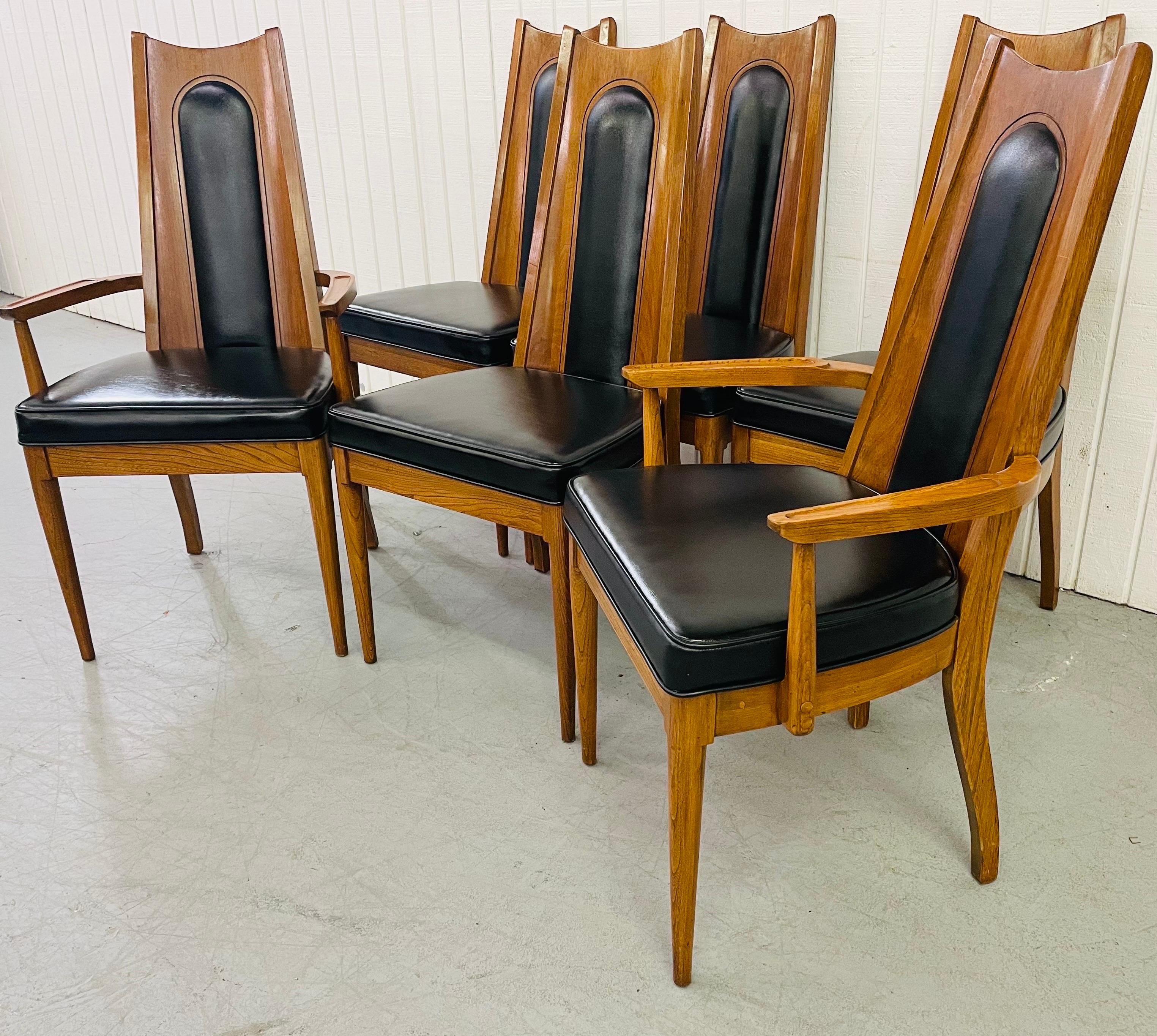 This listing is for a set of six mid-century kent coffey walnut dining chairs. Featuring two arm chairs, four straights, and an original black leather upholstery.