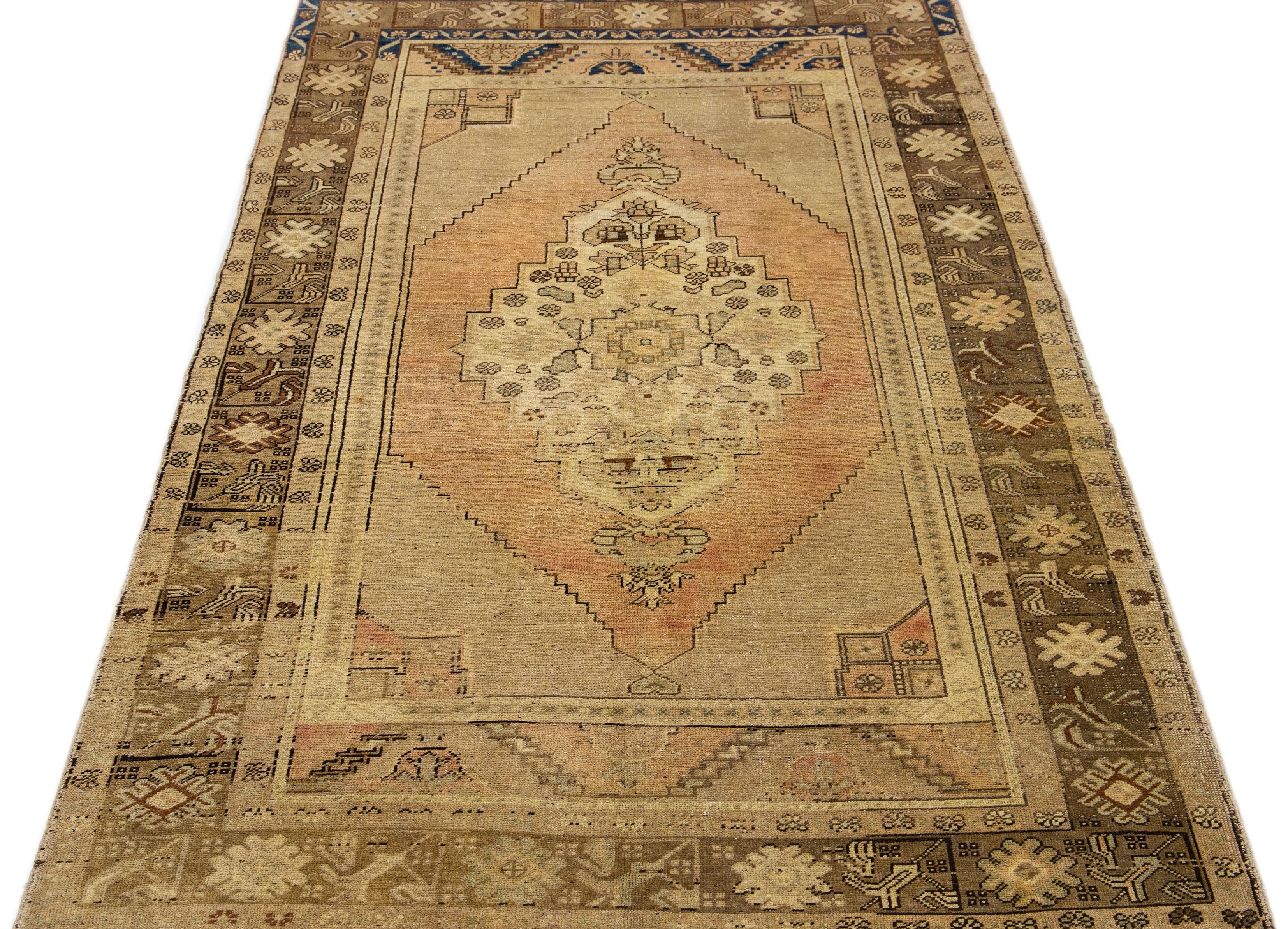 Beautiful vintage Khotan Hand-knotted wool rug with a beige field. This Khotan rug has rust and brown accents in a gorgeous all-over medallion design.

This runner measures 4'10