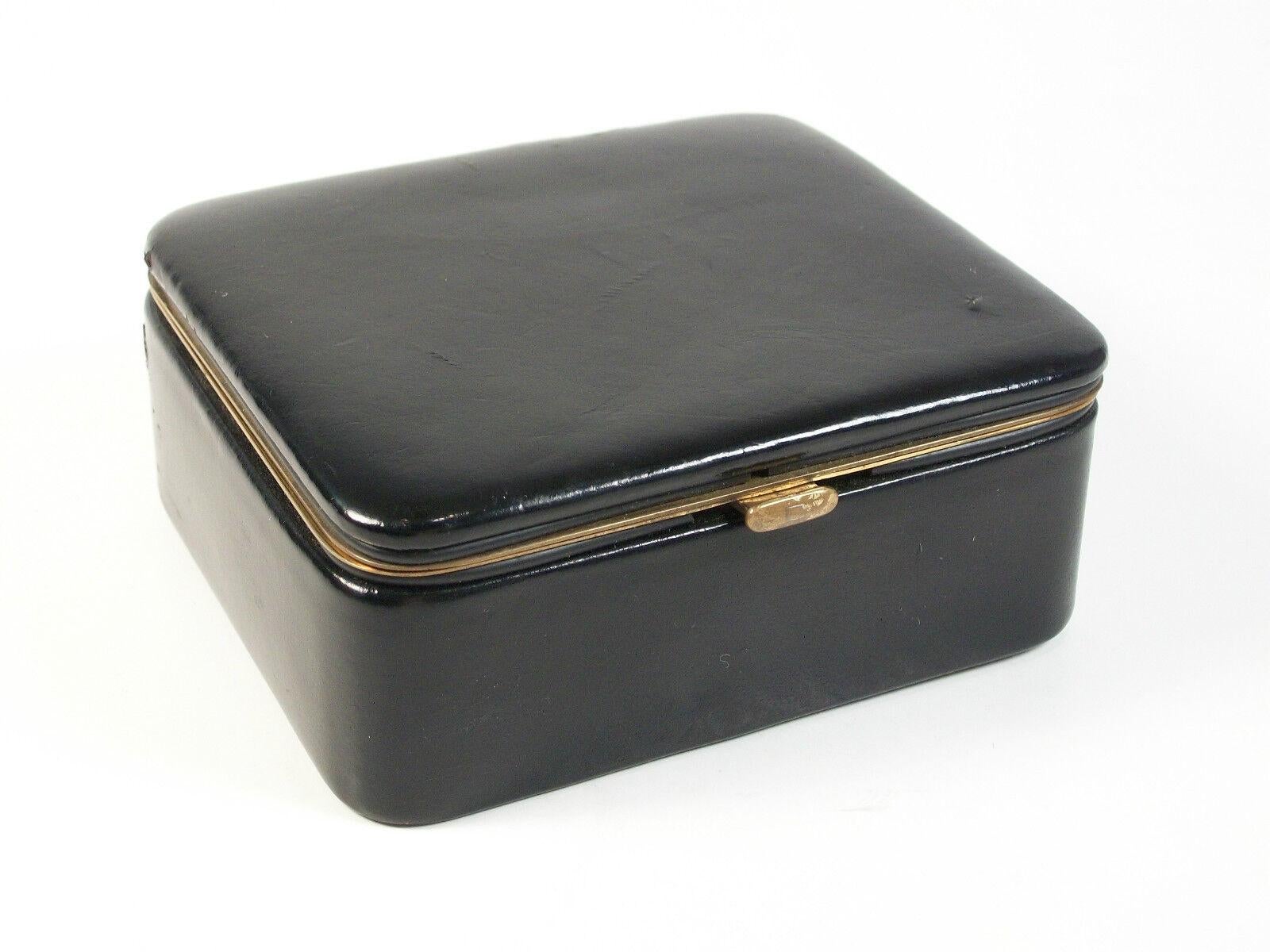 Mid Century - finest quality - genuine kid leather jewelry box/organizer with hinged lid - polished brass details - soft natural suede interior - unsigned - marked in gold letters on the base - MADE IN WEST GERMANY - circa 1960's.  

Excellent