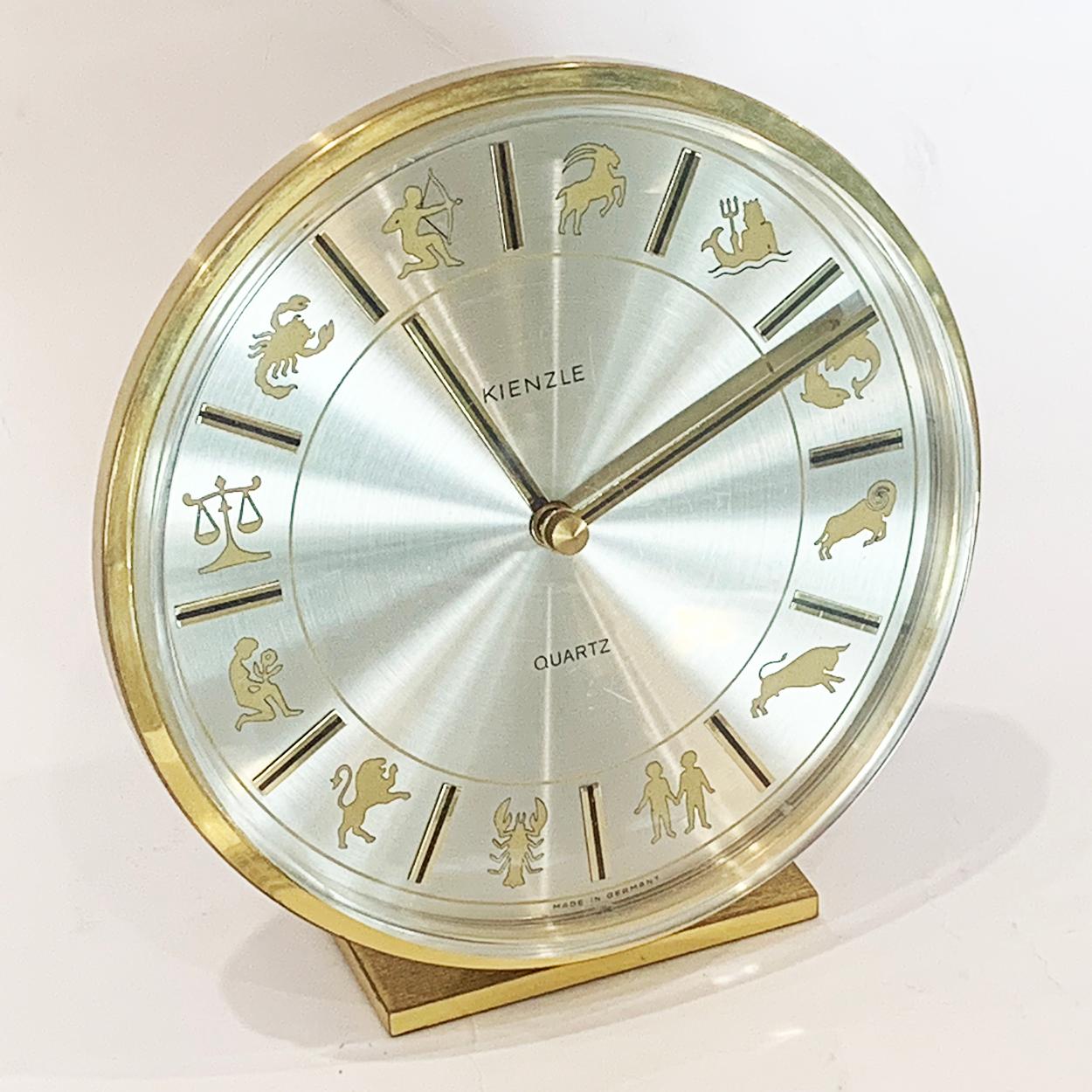 Mid Century, circa 1960, German Clock by Kienzle, with  Zodiac Signs in satin Gilt to face of satin silver face having every 5 minutes with Batons of bright Gilt with a central black stripe, matching the Hour and Minute Hands.
It has very intricate,