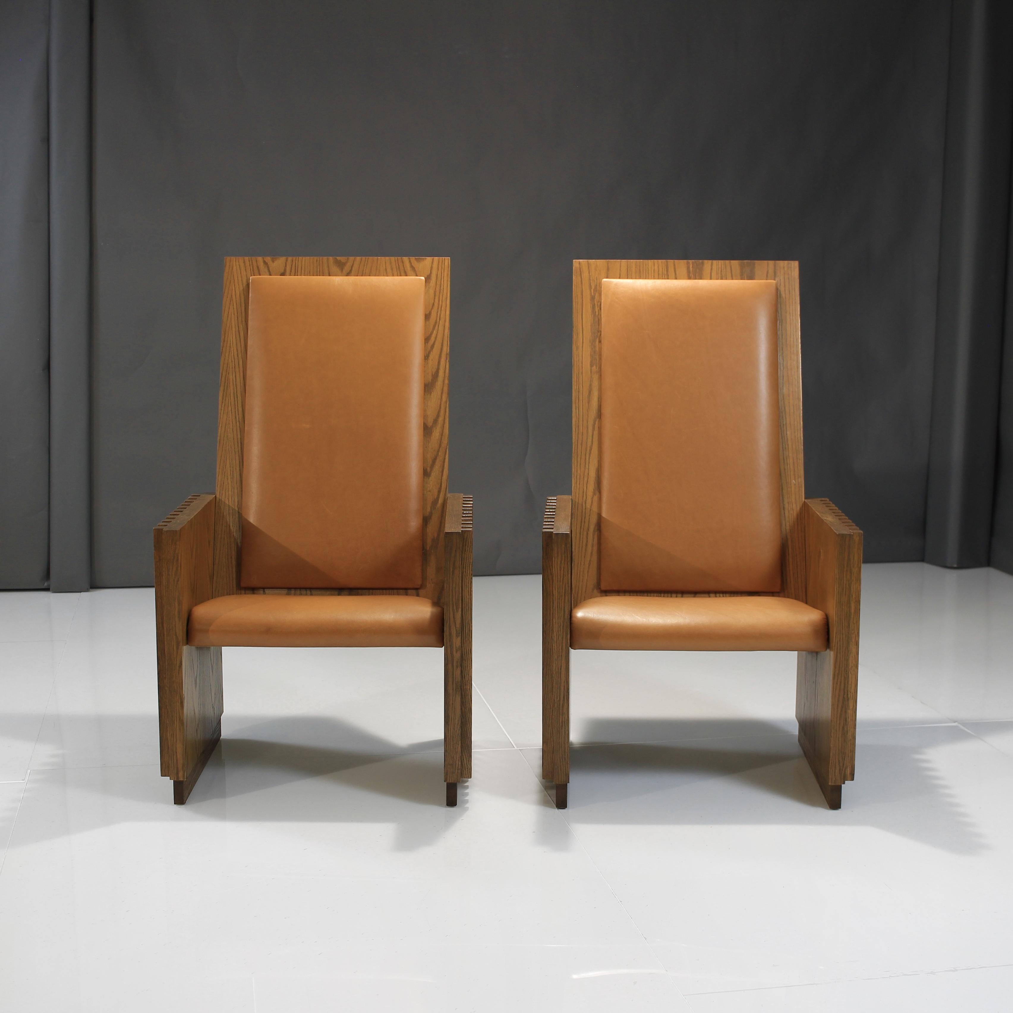 A rare pair of Solid Oak Chairs from the midcentury. Offering incredible visuals, beautiful construction and a very stately presence. Thus we have given them the King and Queen title.

Upholstered in a Caramel Italian Leather showing gorgeous