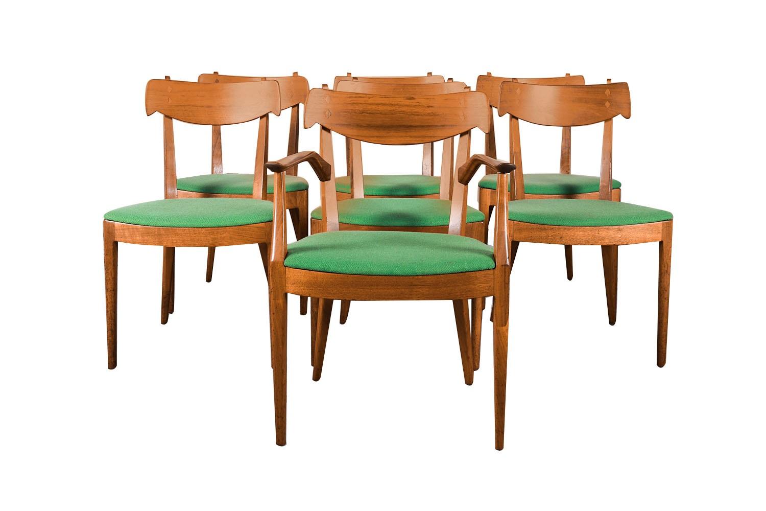 A set of seven extremely sought after, gorgeous 1960s, modern walnut side/dining chairs designed by Kipp Stewart and Stewart MacDougall for Drexel’s Declaration Collection, circa 1960’s. Featuring a full matching set of 7, 1 of which has arms, each
