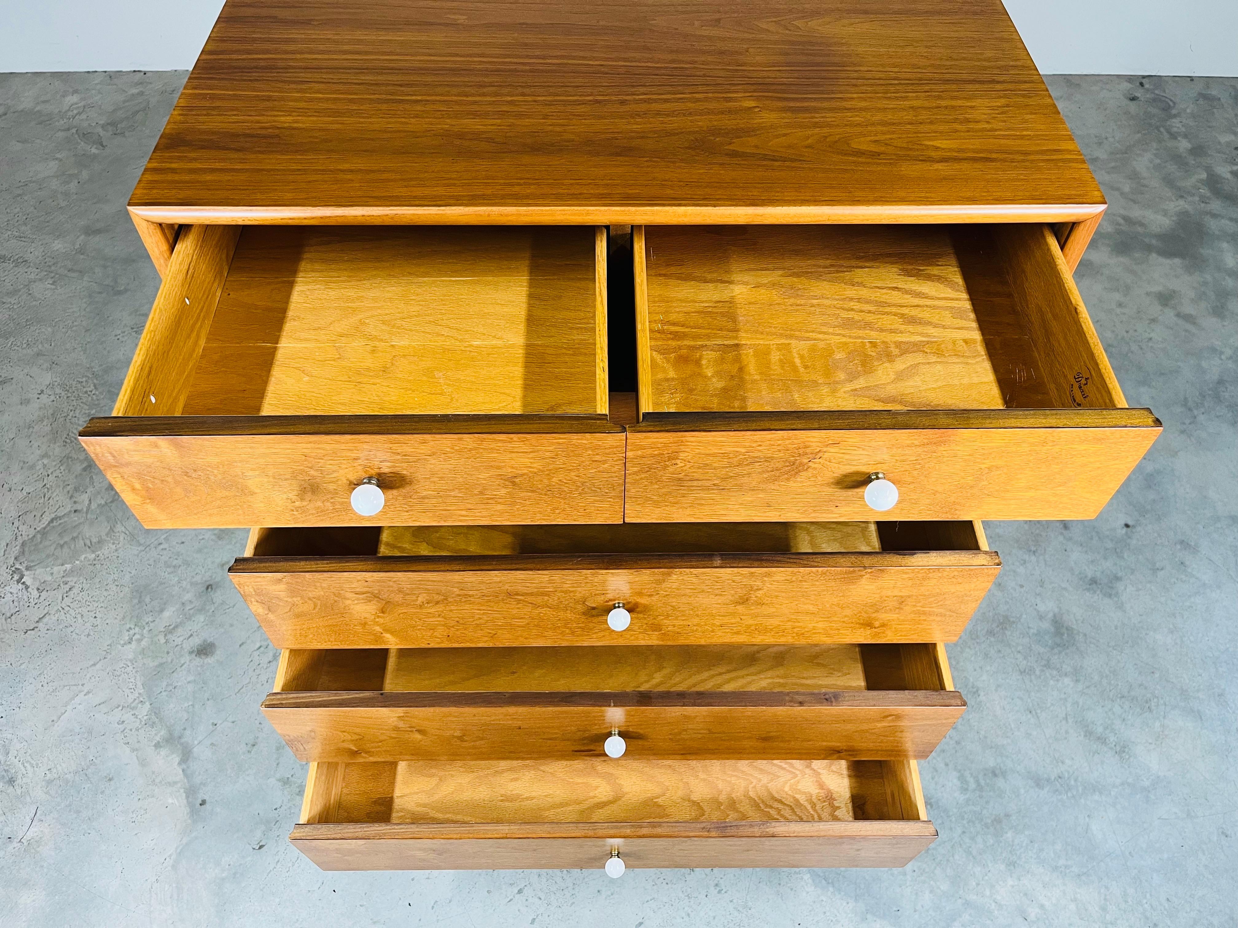 A handsome walnut dresser designed by Kipp Stewart for Drexel having 6 drawers with white porcelain ball pulls. Highly functional with ample storage and will make a beautiful addition to any mid-century modern bedroom layout. We also have the