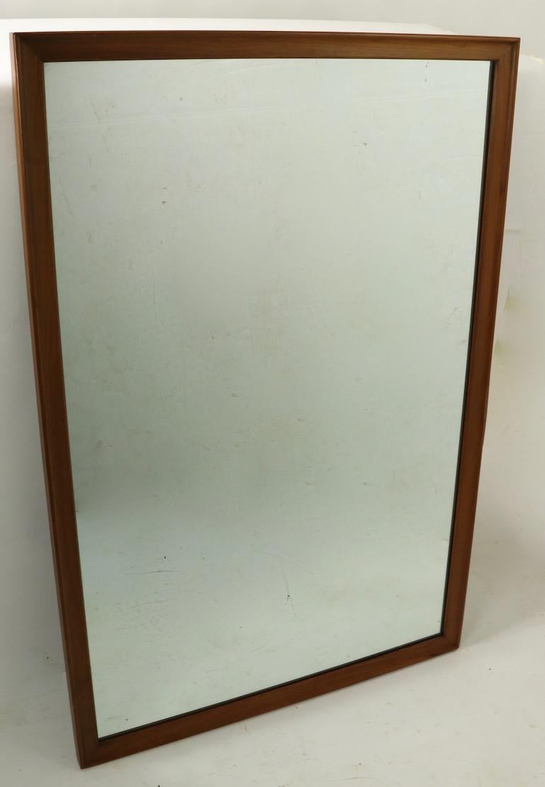 Slick and clean Kipp Stewart for Drexel mirror, having a very tailored wood frame surrounding the plate glass mirror. Architectural design, nice scale, ready to install condition. Currently configured to hang horizontally however we can refit to