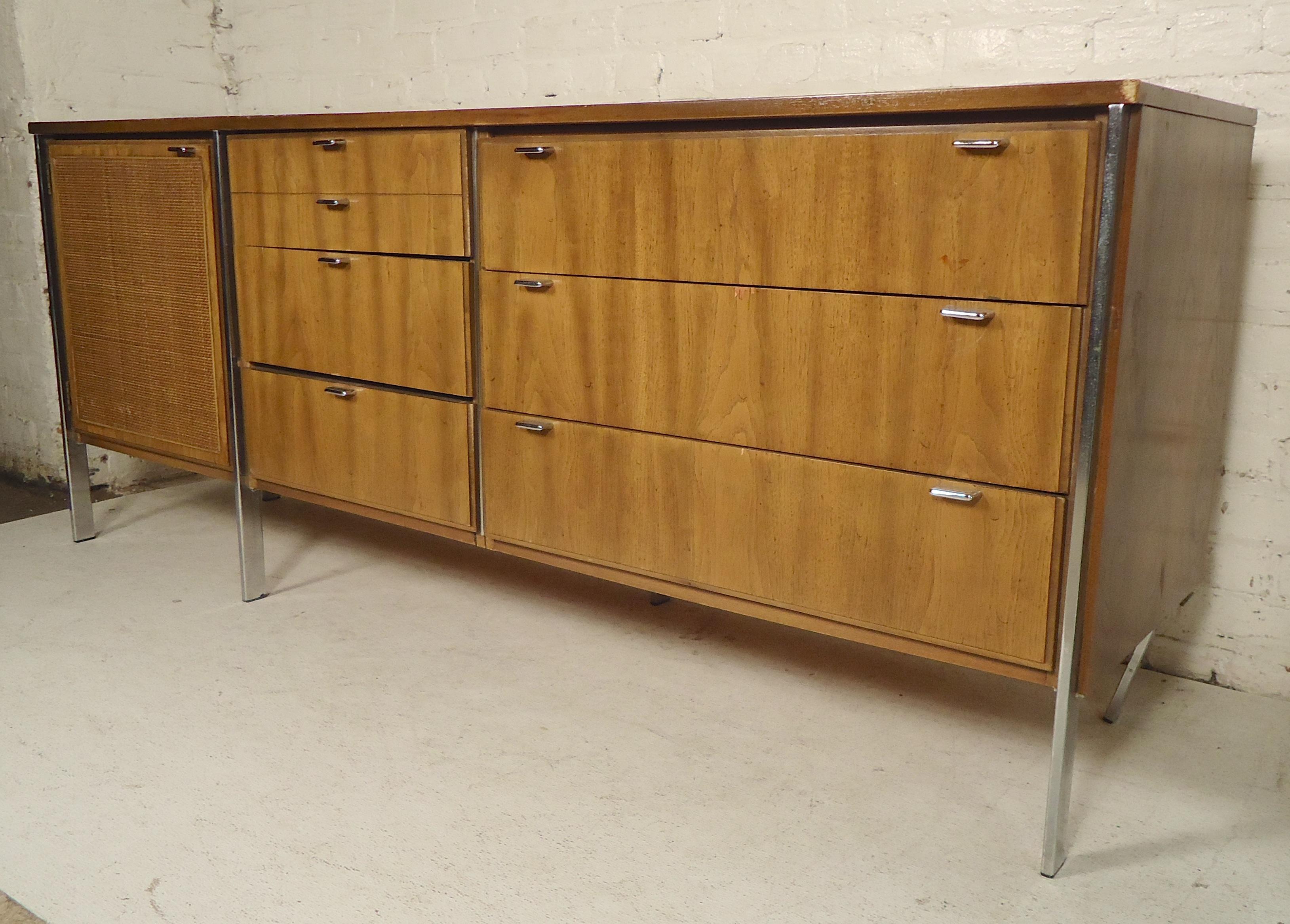 Long sideboard with ample storage for home or office. Nine total drawers with chrome accents and cane front door.

(Please confirm item location - NY or NJ - with dealer).
 