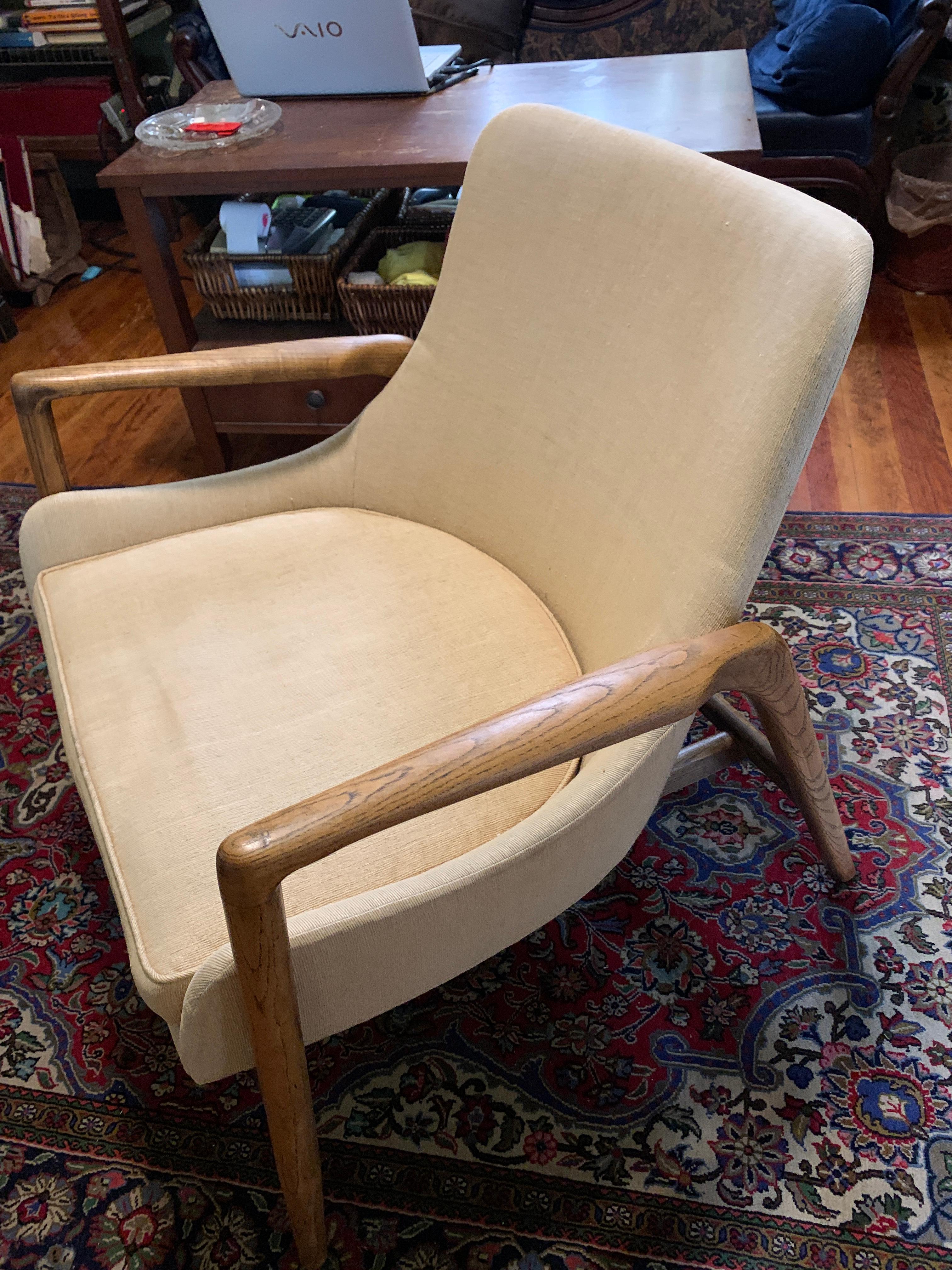 Lounge chair by Ib Kofod Larsen for Selig in Denmark, circa 1950s. Sculptural frame with walnut stain. The well-crafted armrests and barrel shape design shows beautiful details and ensures a comfortable seating experience. 

Height: 28.75 in
 Width: