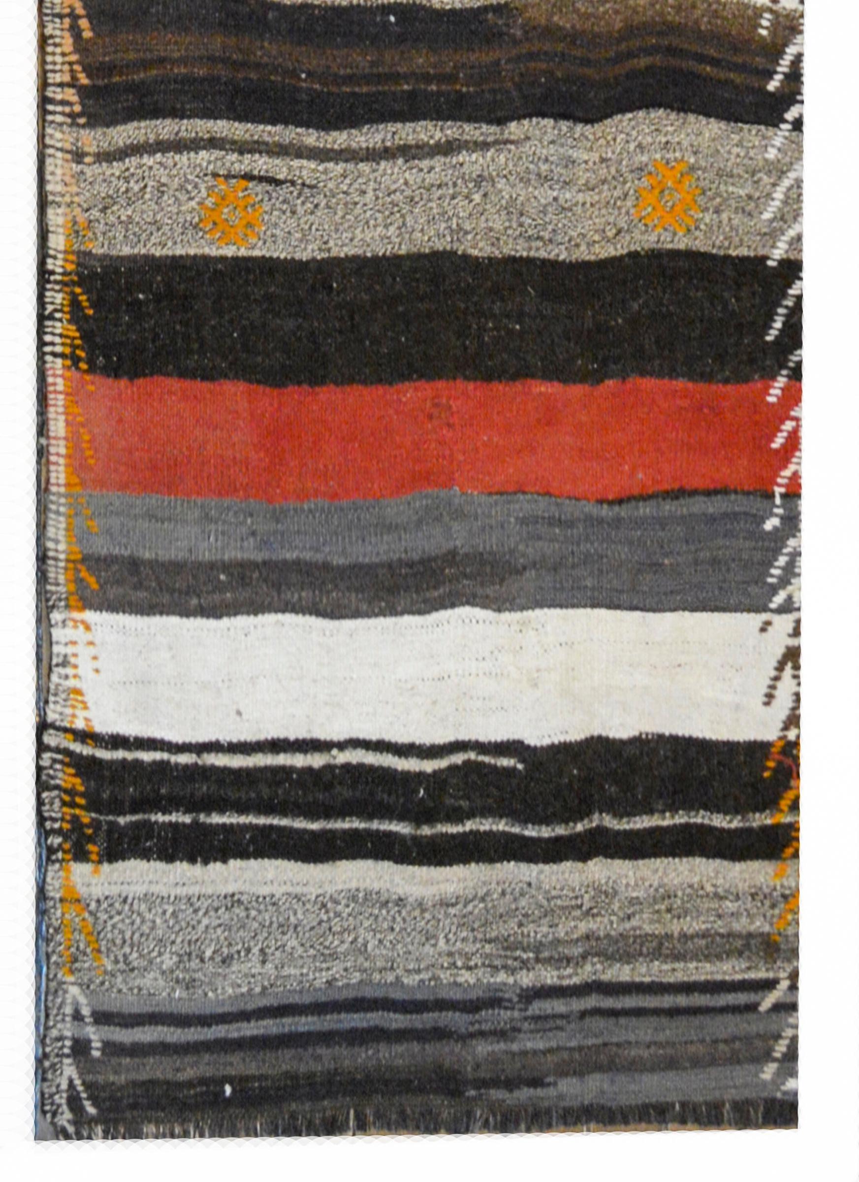 Un fantastico runner Konya Kilim turco della metà del XX secolo con strisce alternate cremisi, arancione, nero, bianco e grigio con fiori stilizzati ricamati e un bordo ricamato.