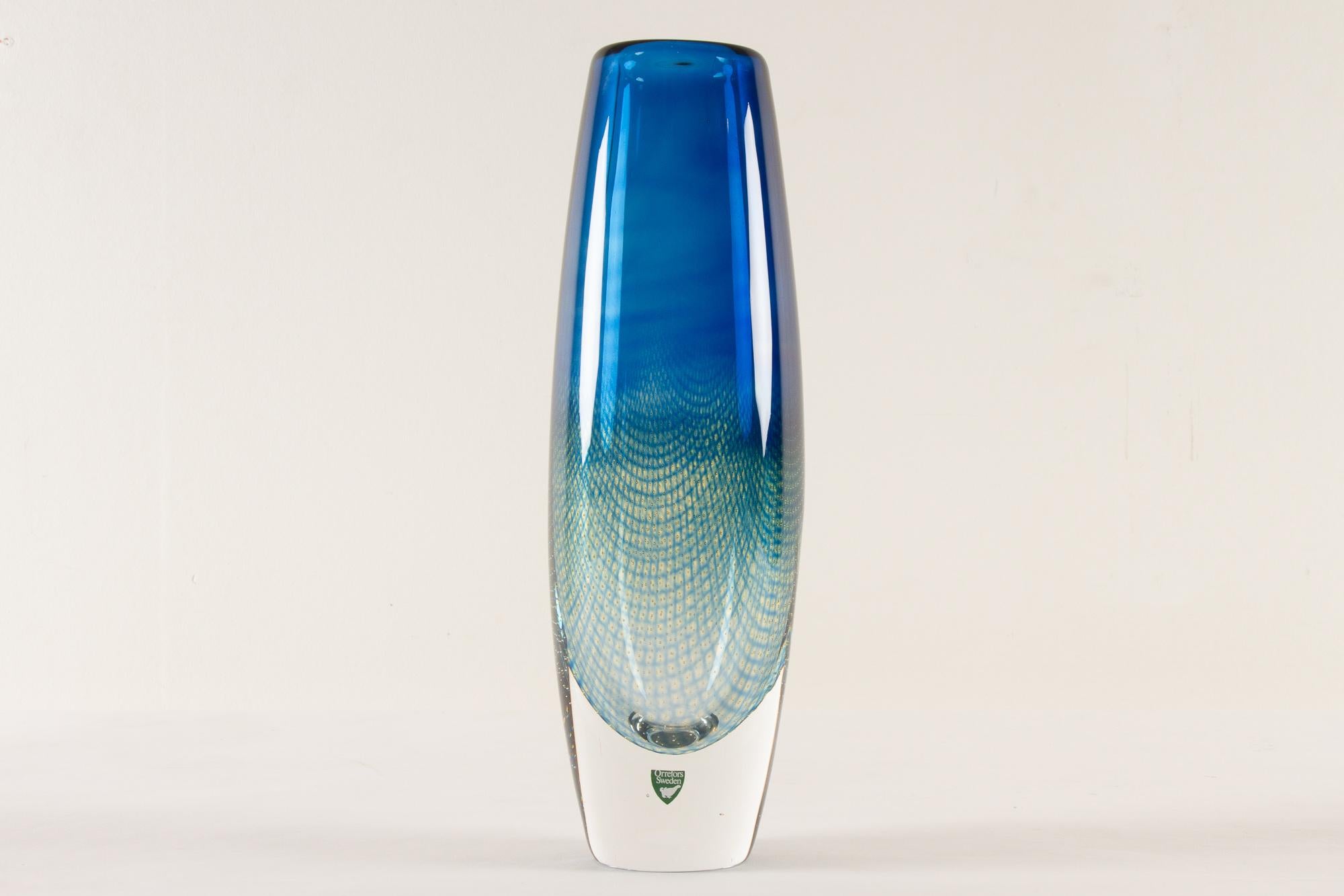 Mid-century Kraka glass Vase by Sven Palmqvist for Orrefors, 1960s
Tall hand blown clear glass vase with blue and green curved net pattern with tiny inlaid air bubbles.
This is a shop display piece with engraved 