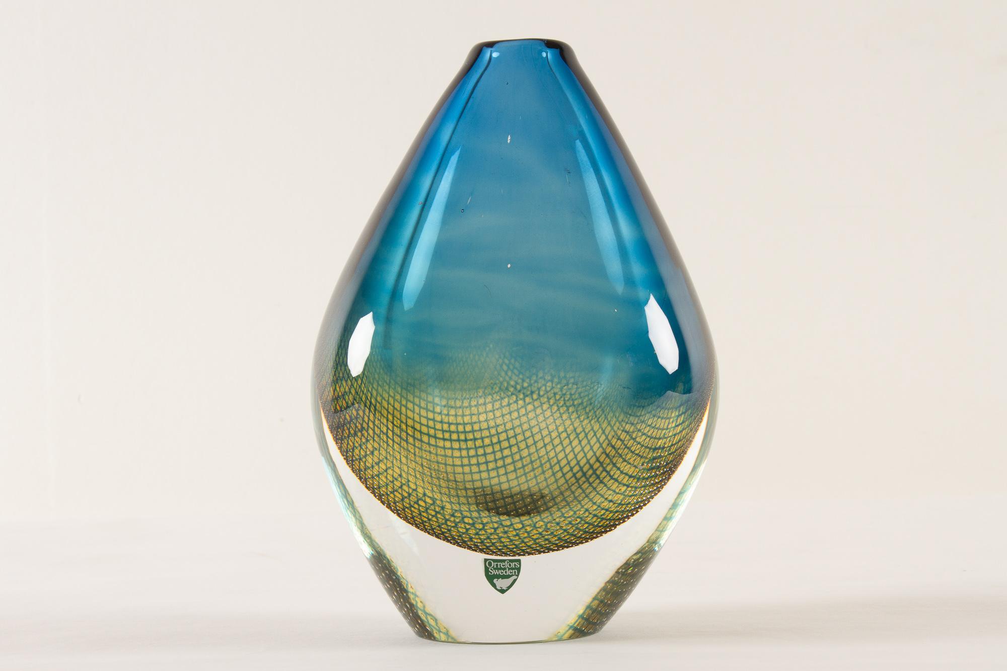 Mid-century Kraka glass vase by Sven Palmqvist for Orrefors, 1960s
Tear shaped hand blown clear glass vase with blue and green curved net pattern with tiny inlaid air bubbles.
This is a shop display piece with engraved 