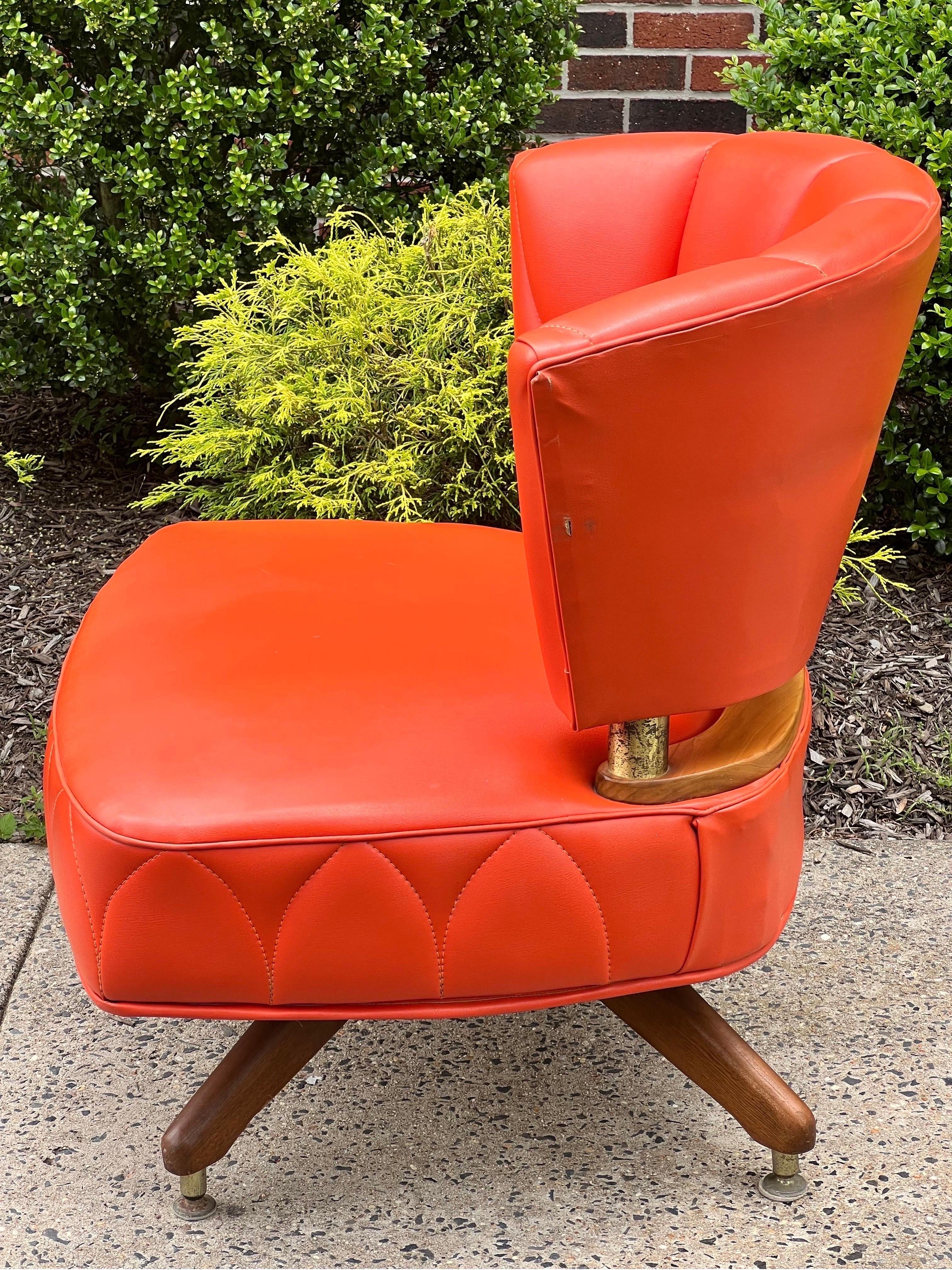 Fabulous vintage swivel slipper chair by Kroehler, 1962.

A beautiful chair upholstered in a vibrant shade of tangerine orange faux leather with unique stitching pattern detail. The upholstery color has maintained its vitality and has no fading. A
