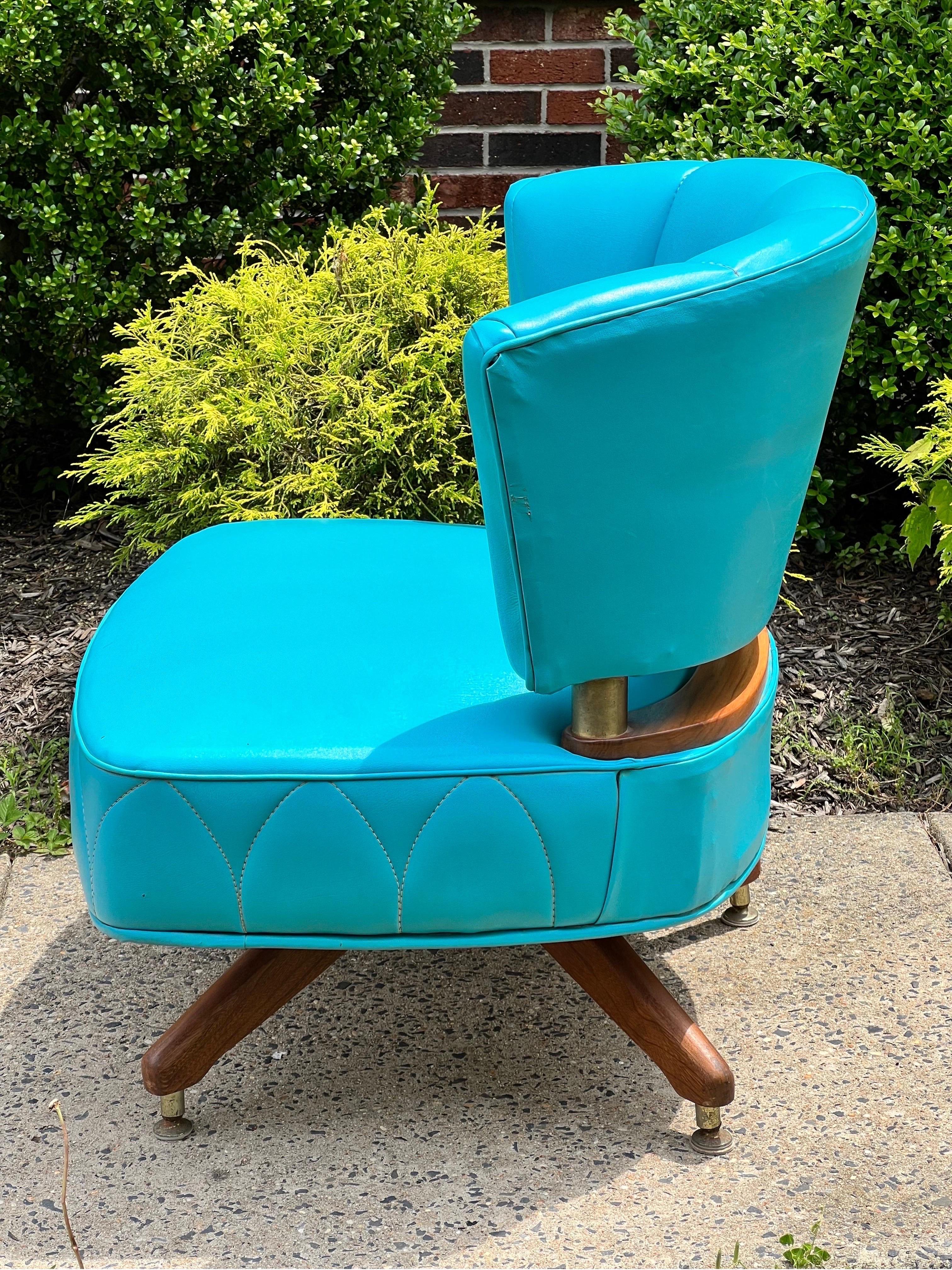 Fabulous vintage swivel slipper chair by Kroehler, 1962.

A beautiful chair upholstered in a vibrant shade of turquoise faux leather with unique stitching pattern detail. The upholstery color has maintained its vitality and has no fading. A generous