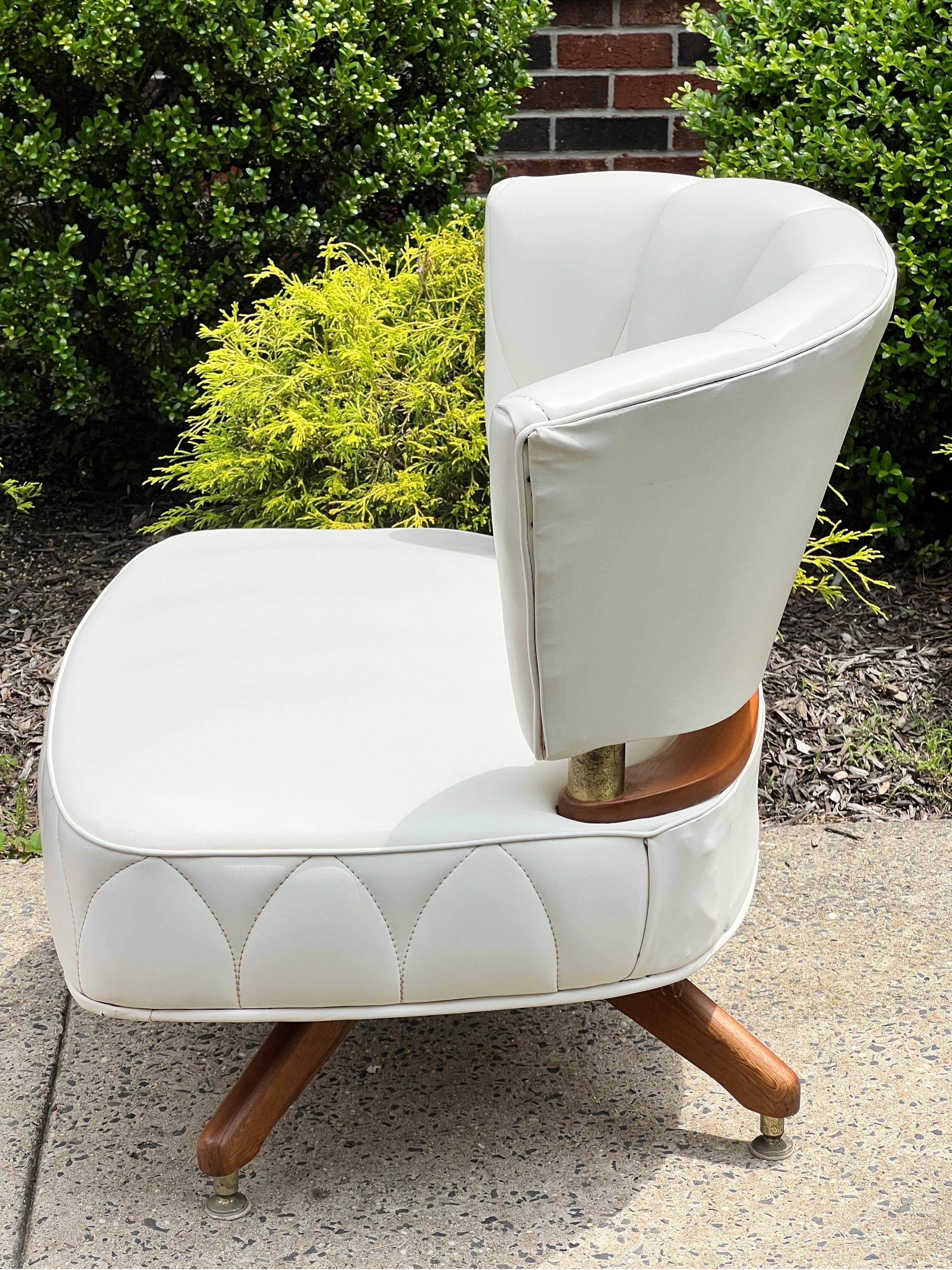 Fabulous vintage swivel slipper chair by Kroehler, 1962. 

A beautiful chair upholstered in a vibrant, creamy shade of white faux leather with unique stitching pattern detail. The upholstery color has maintained its vitality and has no fading. A