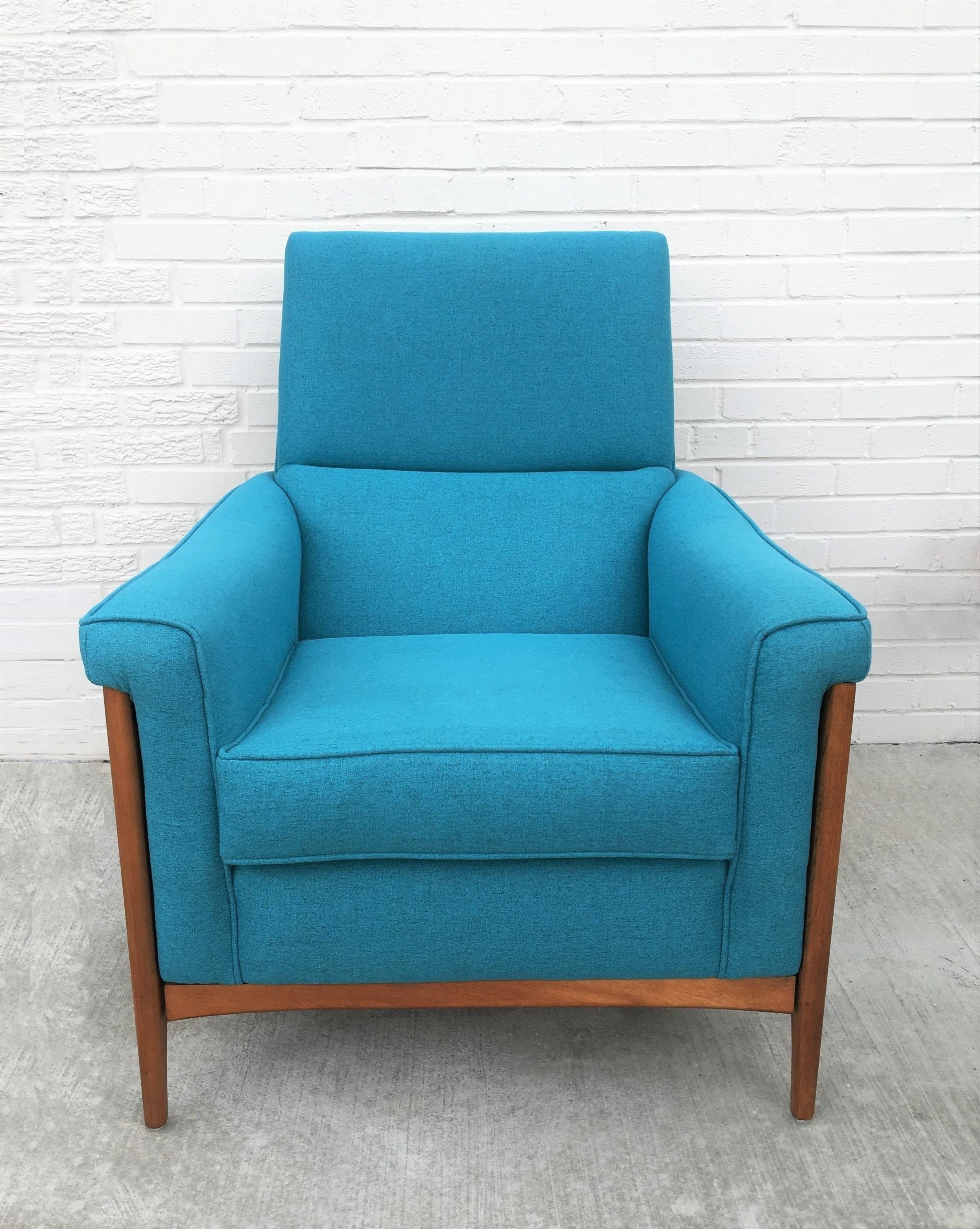 Well designed pair of sculptural armchairs by the Kroehler Co. Featuring blue fabric upholstery, solid American wood construction with comfortable deep seats. The sculptural legs reach up to the sloping arm rests of the chairs that brings a classy