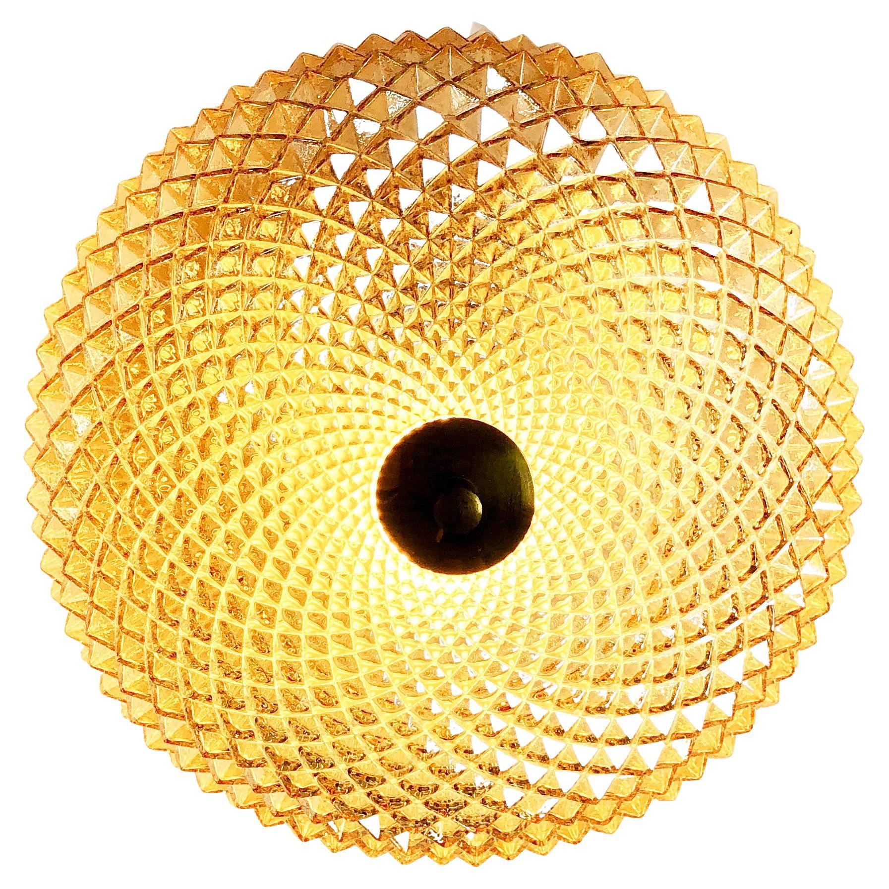 Magnificent, flush base ceiling lamp by 'RZB Leuchten', one of Germany's famous mid century manufacturer of high-end design lighting.
Comes in a round shape, spiky like a Mexica cacti: made from transparent glas: gold shimmering with a kind of soap