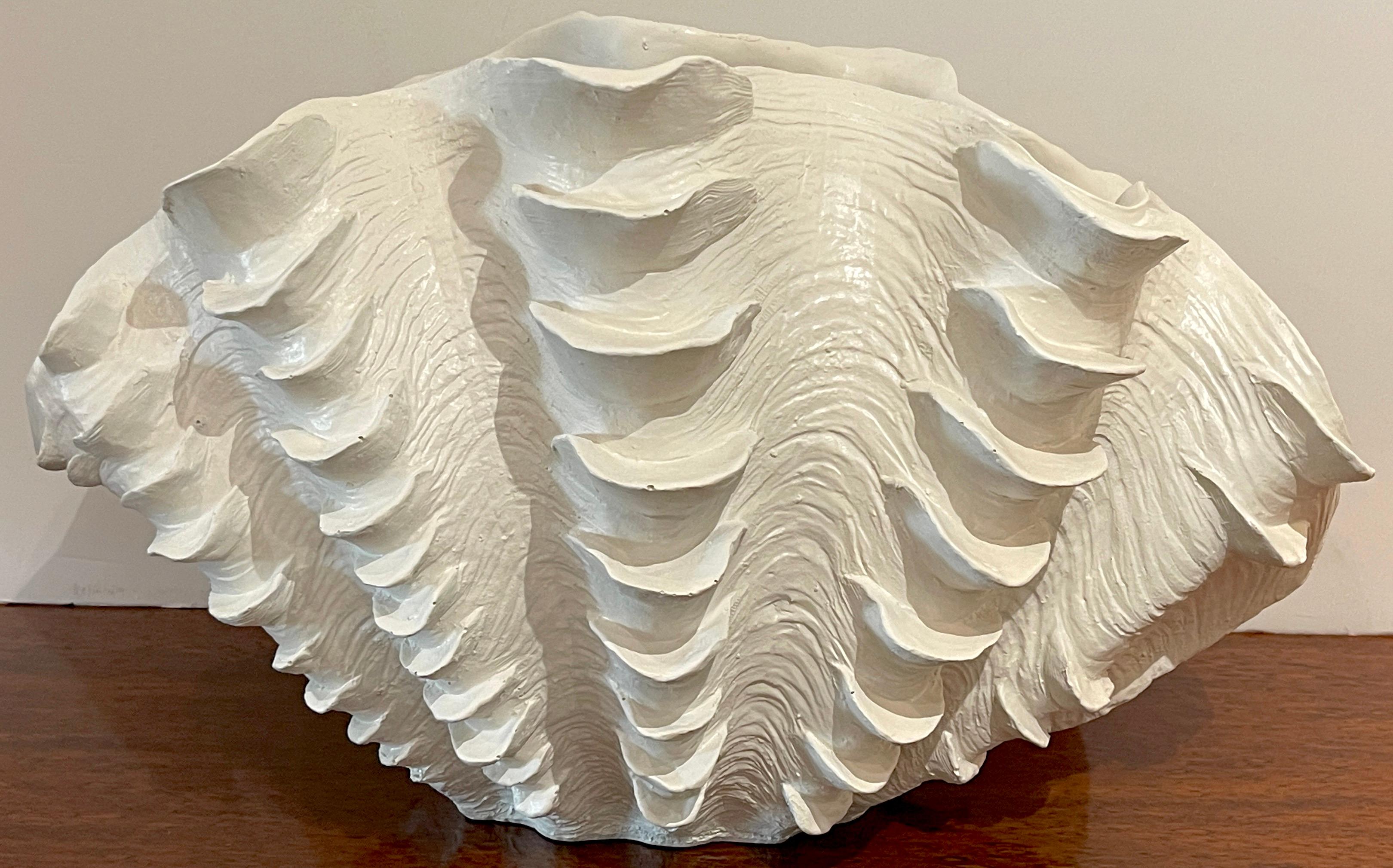 Mid century lacquered Giant Clam (Tridacna Gigas) shell vase
A large realistically modeled and white lacquered vase, can be used upright or on its side as a natural semi-opened clam shell.
The base measures 7-Inches wide x inches deep
Overall
