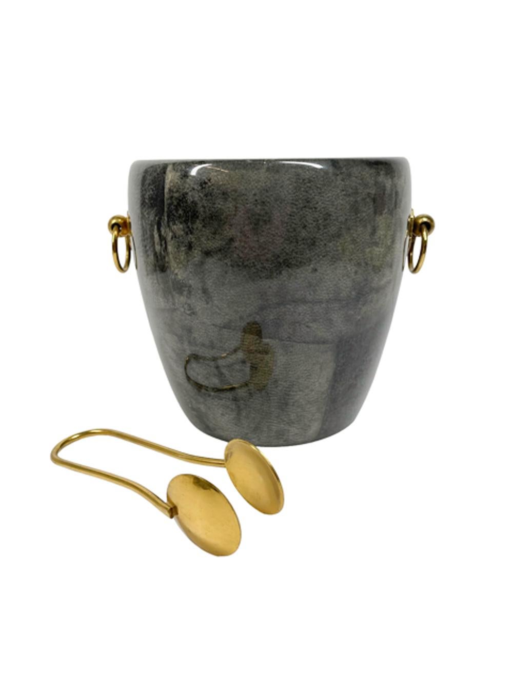Mid-Twentieth Century grey stained and lacquered goatskin ice bucket with gilt metal ring handles, liner and tongs.
