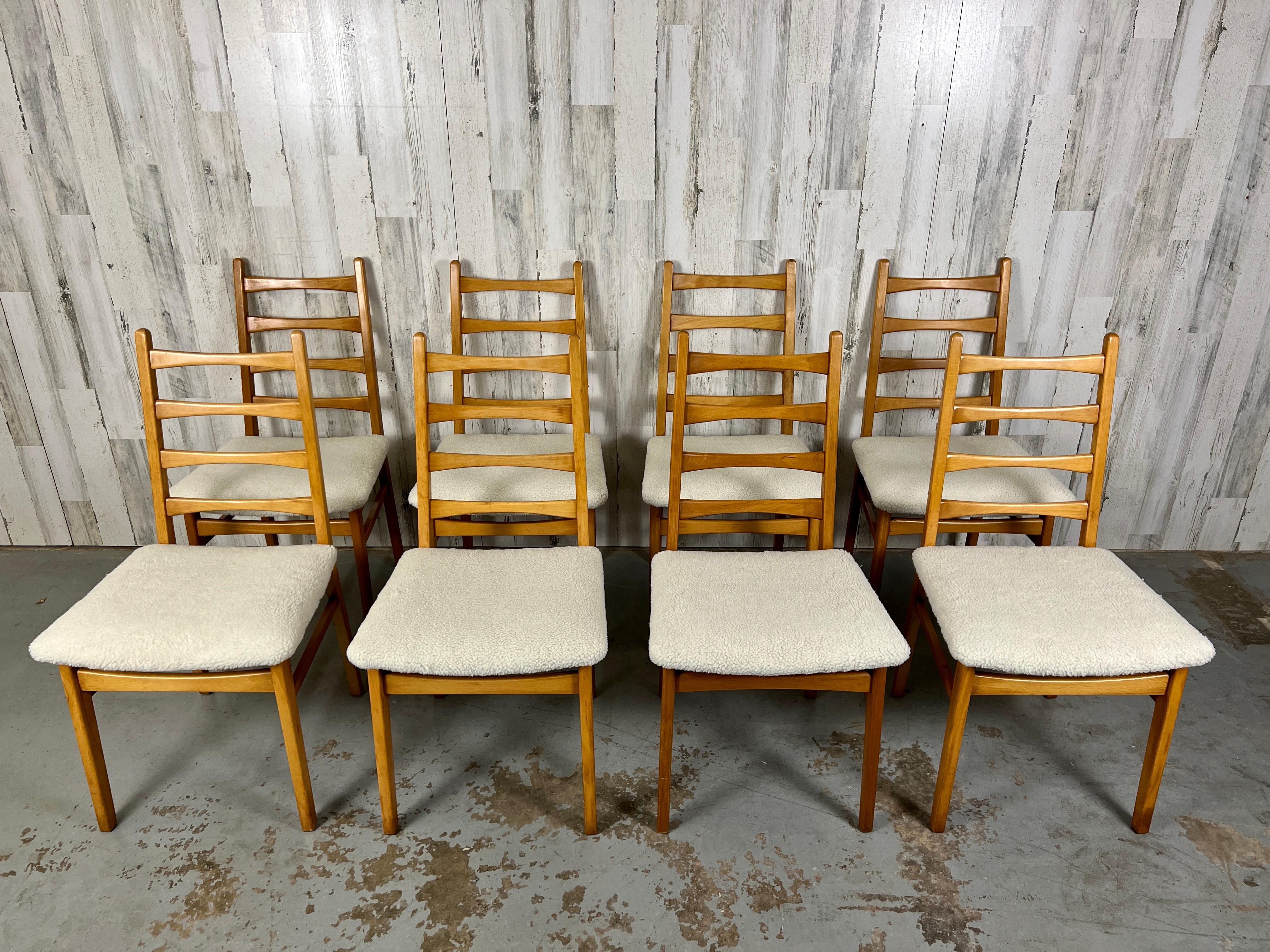 Set of 8 Mid Century Ladder Back Beechwood dining chairs in the style of Niels Kofoed. New fuzzy sherpa fabric makes a very comfortable seat. Made in East Germany.