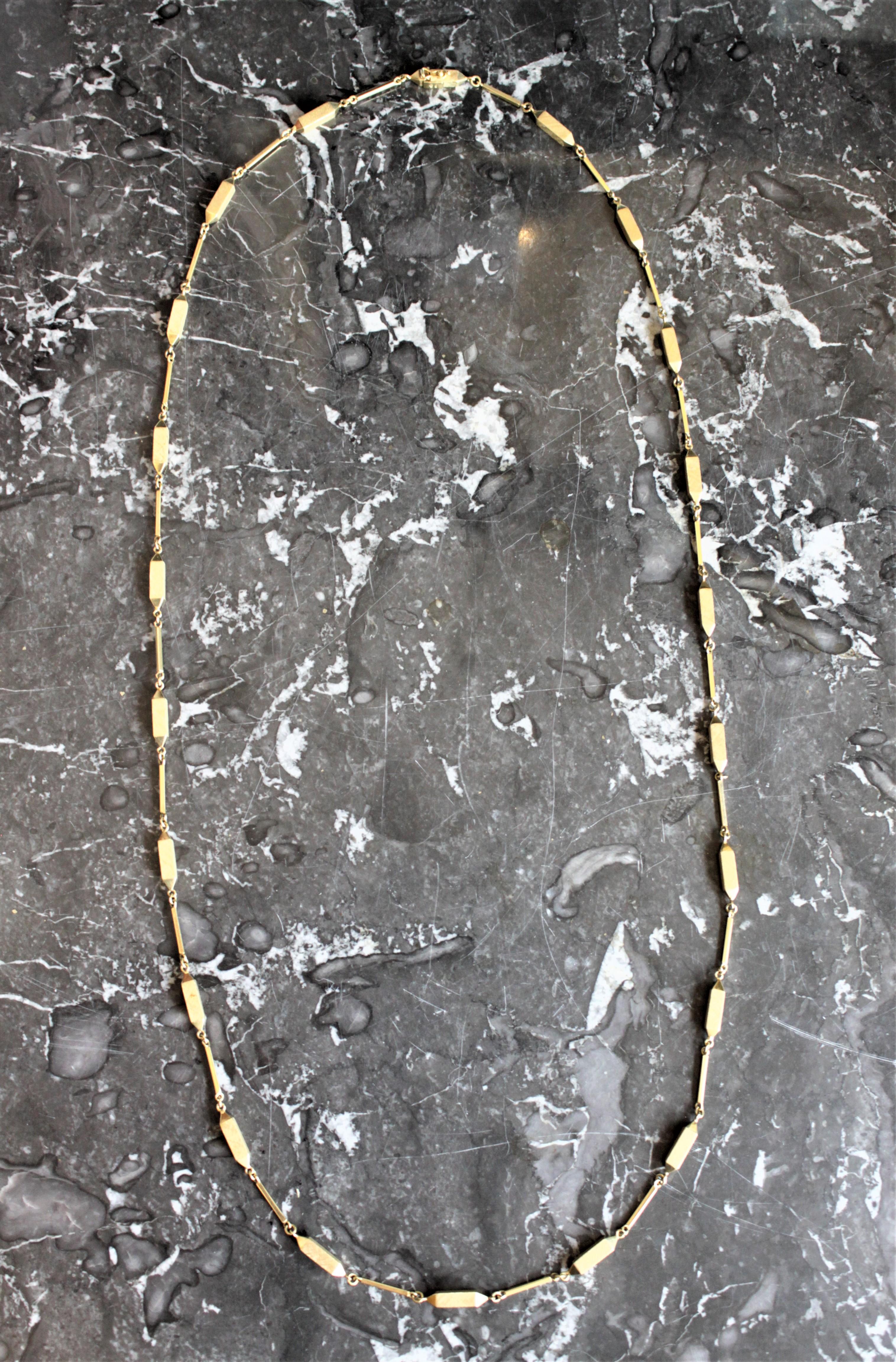 This midcentury ladies 18-karat yellow gold necklace dates from the 1970s and has very unique modernist styled geometric links. This chain is quite substantial in length and measures 41 inches. The maker is unknown, however given the uniqueness of