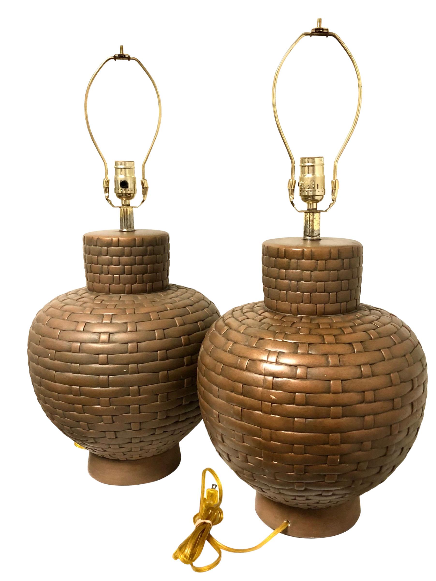 Pair of lamps mid century early 1970s maybe even mid 60s. They are made of plaster of paris, faux painted to look like they are woven. Lamps are perfect. They are in perfect working condition and have a new cord in clear gold. Finished off with felt